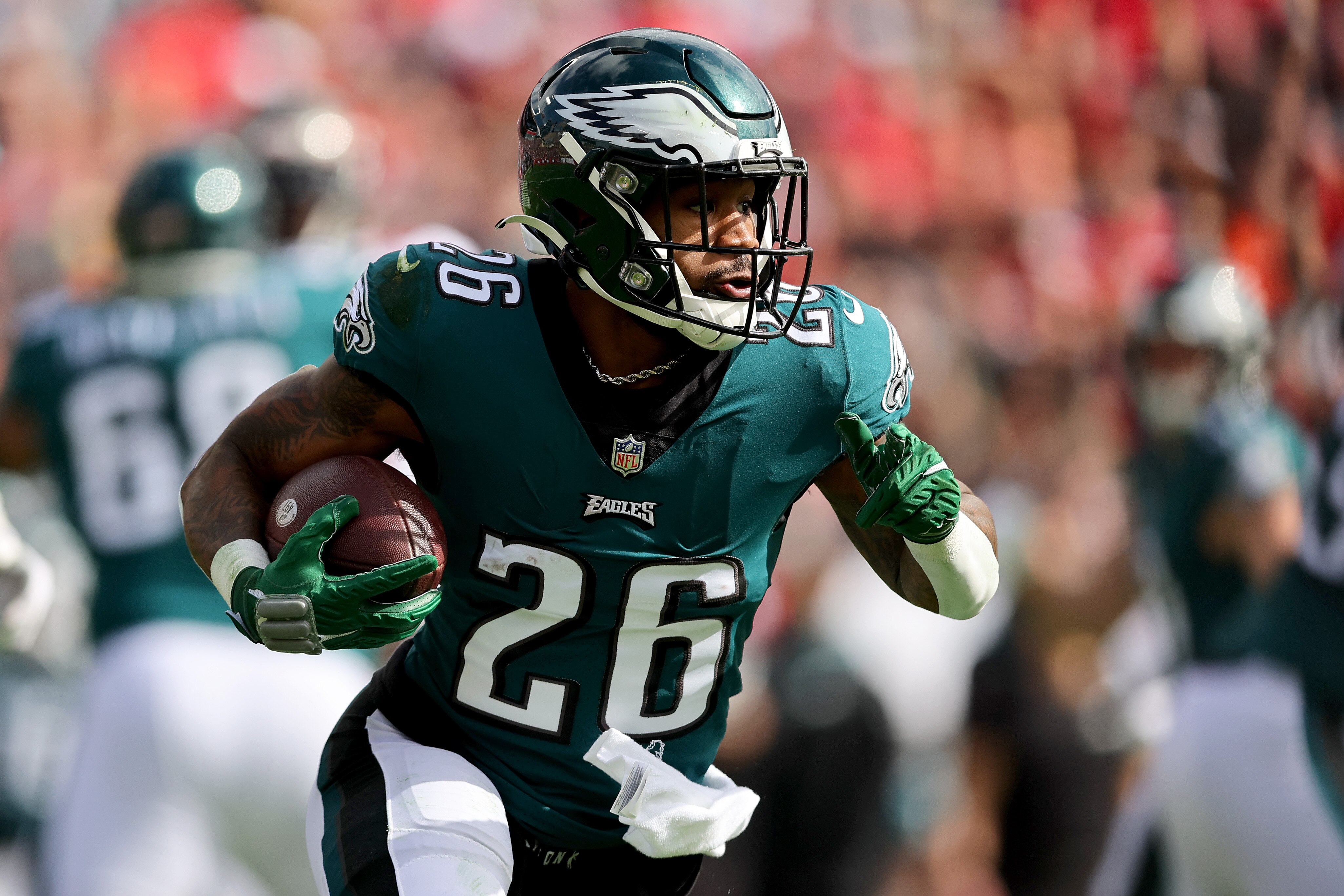TAMPA, FLORIDA - JANUARY 16: Miles Sanders #26 of the Philadelphia Eagles runs the ball against the Tampa Bay Buccaneers during the first quarter in the NFC Wild Card Playoff game at Raymond James Stadium on January 16, 2022 in Tampa, Florida. (Photo by Michael Reaves/Getty Images)