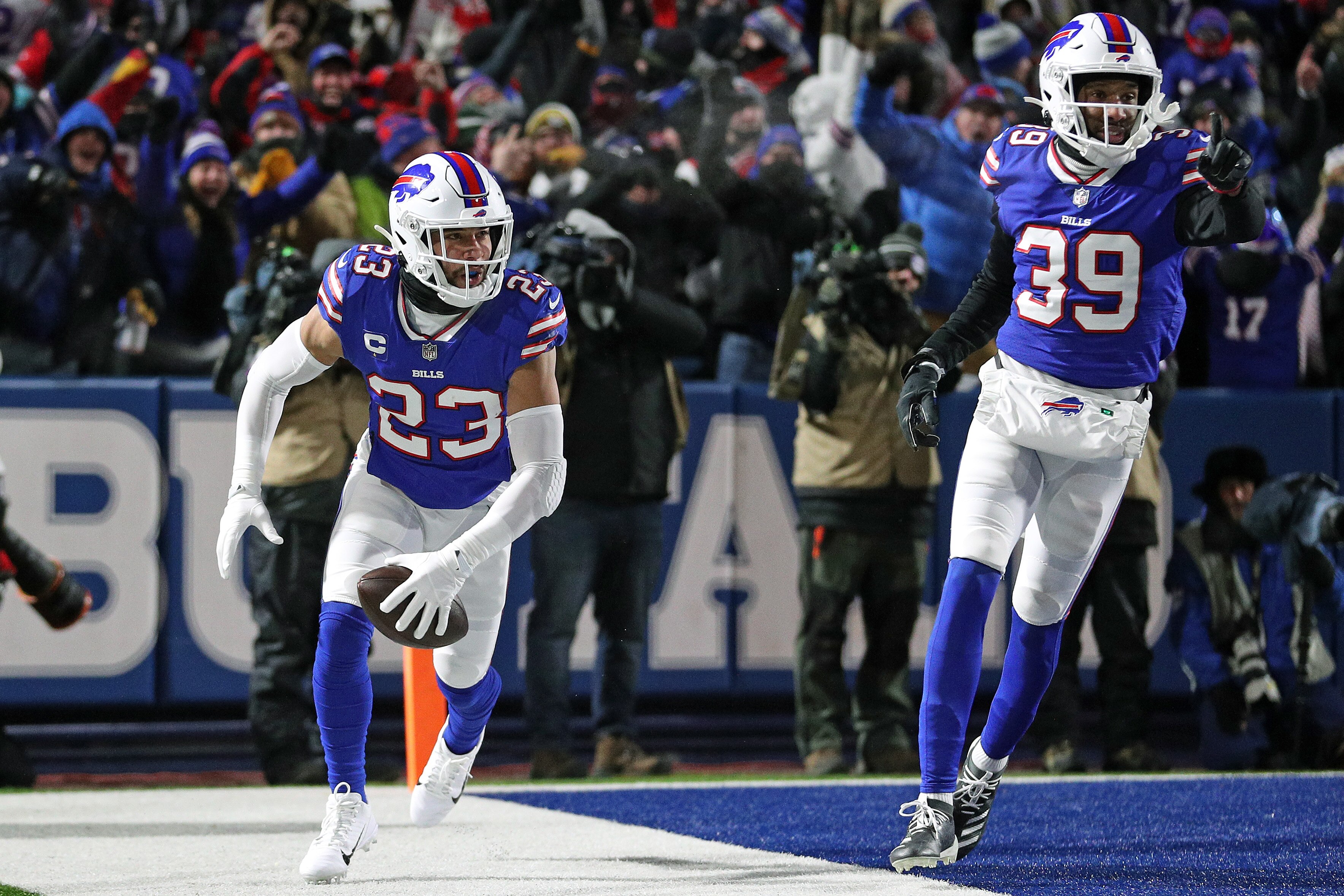 BUFFALO, NEW YORK - JANUARY 15: Micah Hyde #23 of the Buffalo Bills celebrates with Levi Wallace #39 after an interception thrown by Mac Jones #10 of the New England Patriots during the first quarter in the AFC Wild Card playoff game at Highmark Stadium on January 15, 2022 in Buffalo, New York. (Photo by Bryan M. Bennett/Getty Images)