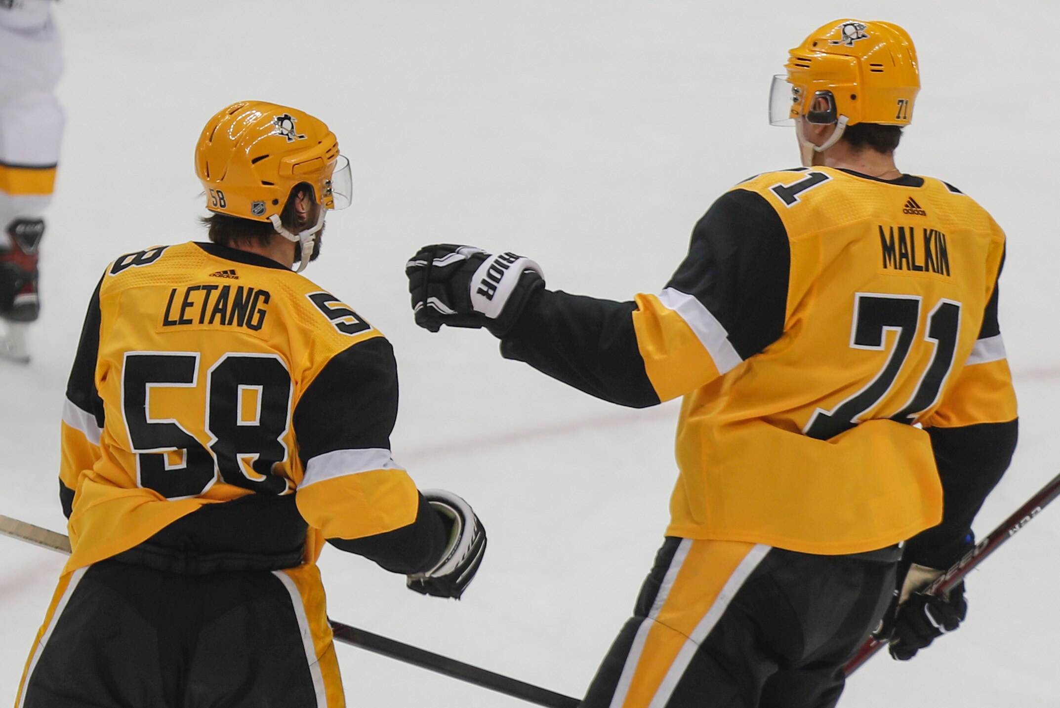 Pittsburgh Penguins' Evgeni Malkin (71) congratulates Kris Letang after assisting Letang on a goal against the Nashville Predators during the first period of an NHL hockey game, Saturday, Dec. 28, 2019, in Pittsburgh. (AP Photo/Keith Srakocic)