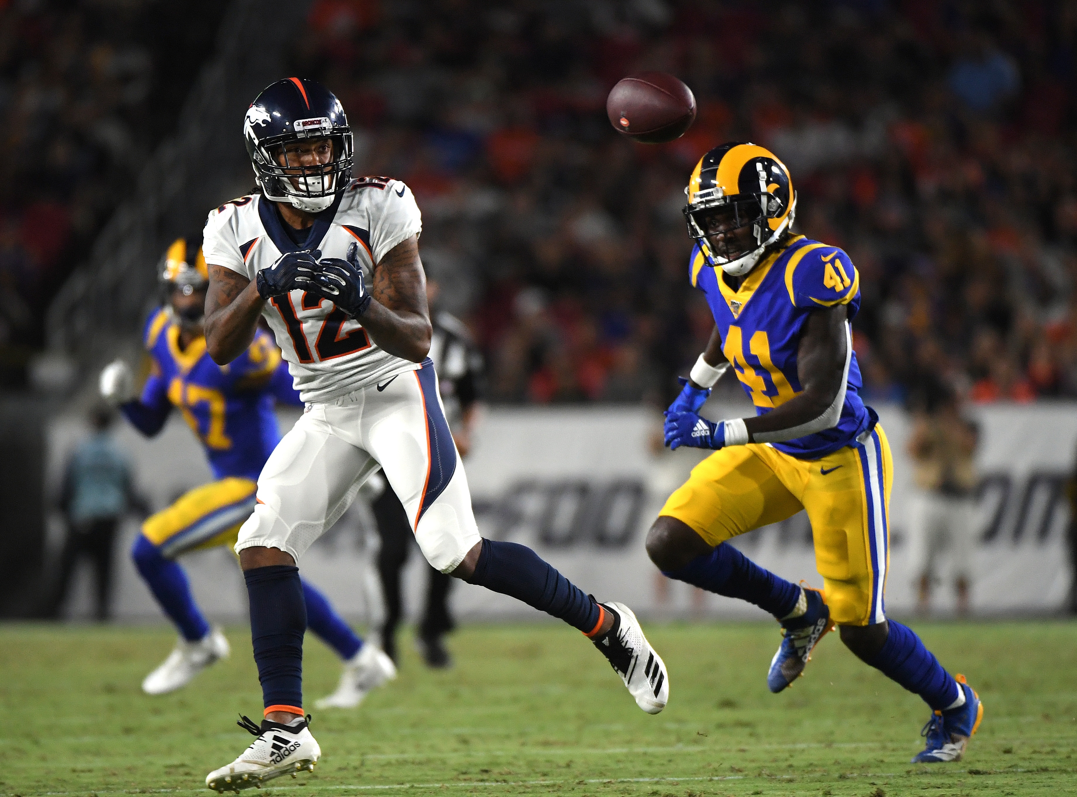 LOS ANGELES, CALIFORNIA - AUGUST 24:  Brendan Langley #12 of the Denver Broncos prepares for a catch in front of David Long #41 of the Los Angeles Rams during second half of a preseason game at Los Angeles Memorial Coliseum on August 24, 2019 in Los Angeles, California. (Photo by Harry How/Getty Images)