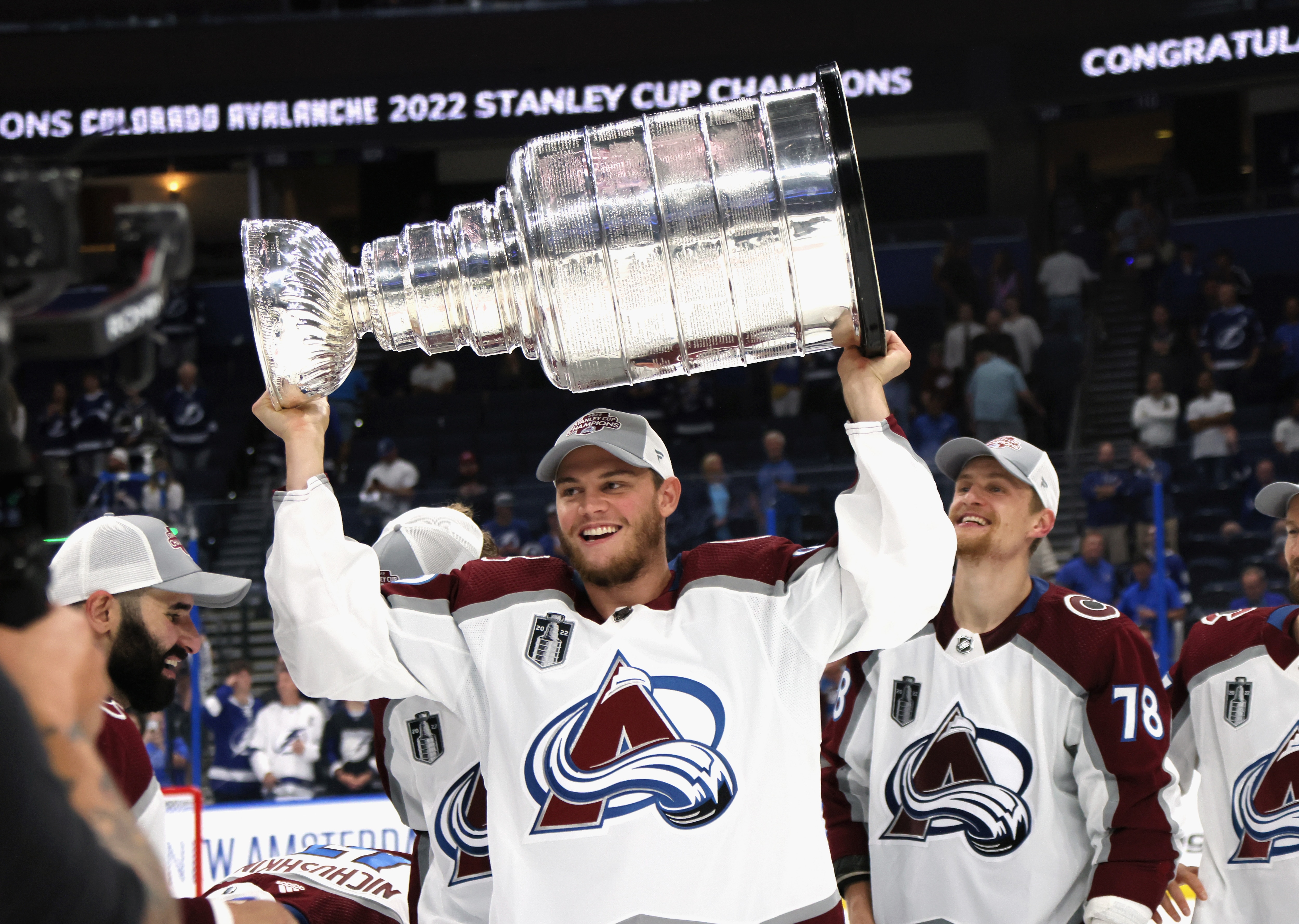 TAMPA, FLORIDA - JUNE 26: Andre Burakovsky #95 of the Colorado Avalanche carries the Stanley Cup following the series winning victory over the Tampa Bay Lightning in Game Six of the 2022 NHL Stanley Cup Final at Amalie Arena on June 26, 2022 in Tampa, Florida. (Photo by Bruce Bennett/Getty Images)