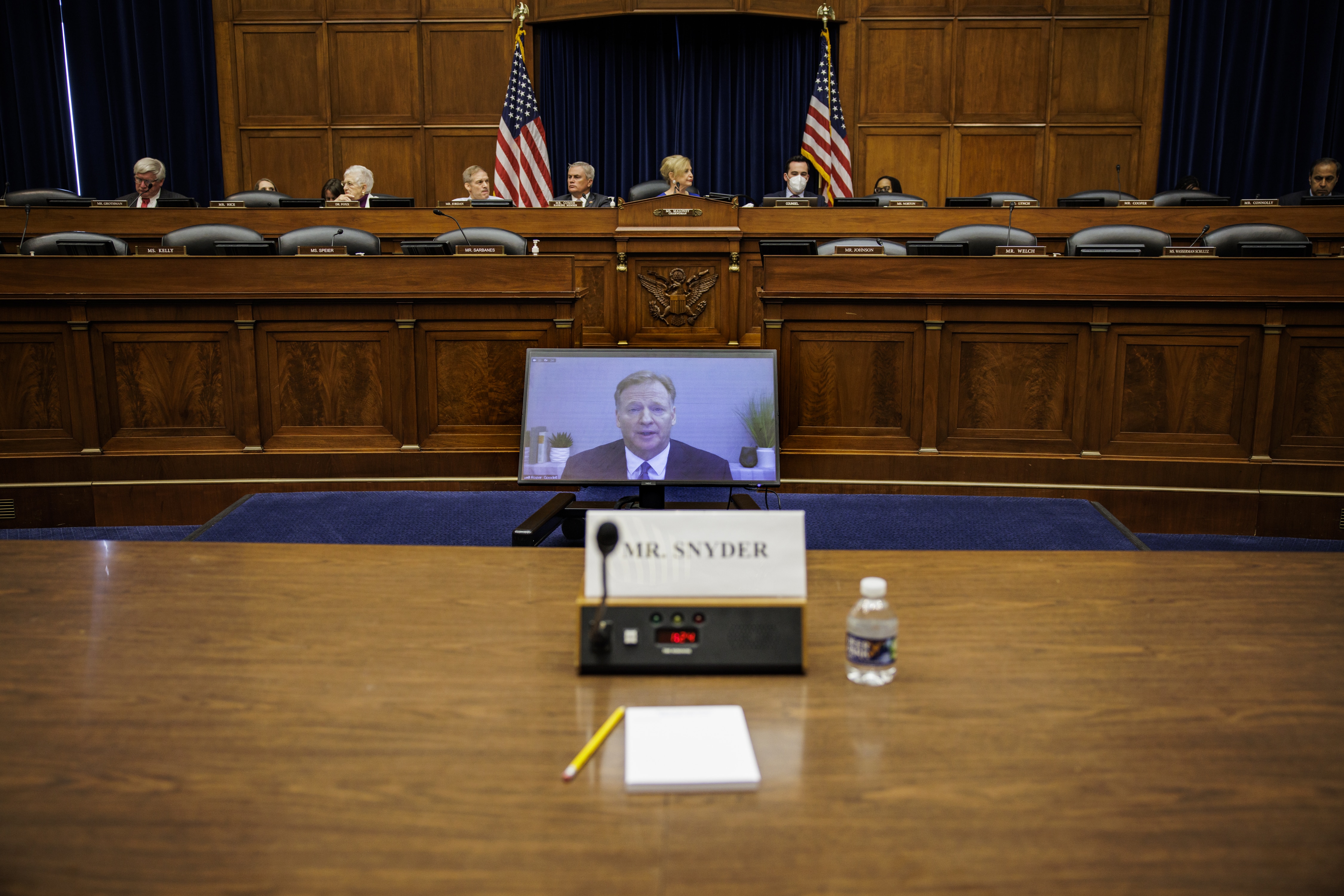 An empty seat marked for Dan Snyder, owner of the Washington Commanders football team, as RogerGoodel, commissioner of the National Football League (NFL), center, speaks via videoconference during a House Oversight and Reform Committee hearing in Washington, D.C., US, on Wednesday, June 22, 2022. The hearing is looking into how the NFL has handled allegations of workplace misconduct by the Washington Commanders football team. Photographer: Samuel Corum/Bloomberg via Getty Images