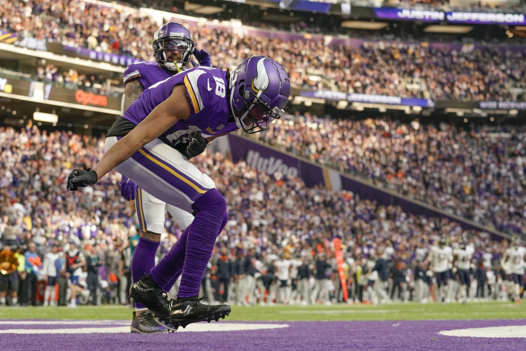 MINNEAPOLIS, MN - JANUARY 09: Minnesota Vikings Wide Receiver Justin Jefferson (18) celebrates his 45-yard touchdown reception from Minnesota Vikings Quarterback Kirk Cousins (8) during a game between the Minnesota Vikings and Chicago Bears on January 9, 2022, at U.S. Bank Stadium in Minneapolis, MN.(Photo by Nick Wosika/Icon Sportswire via Getty Images)