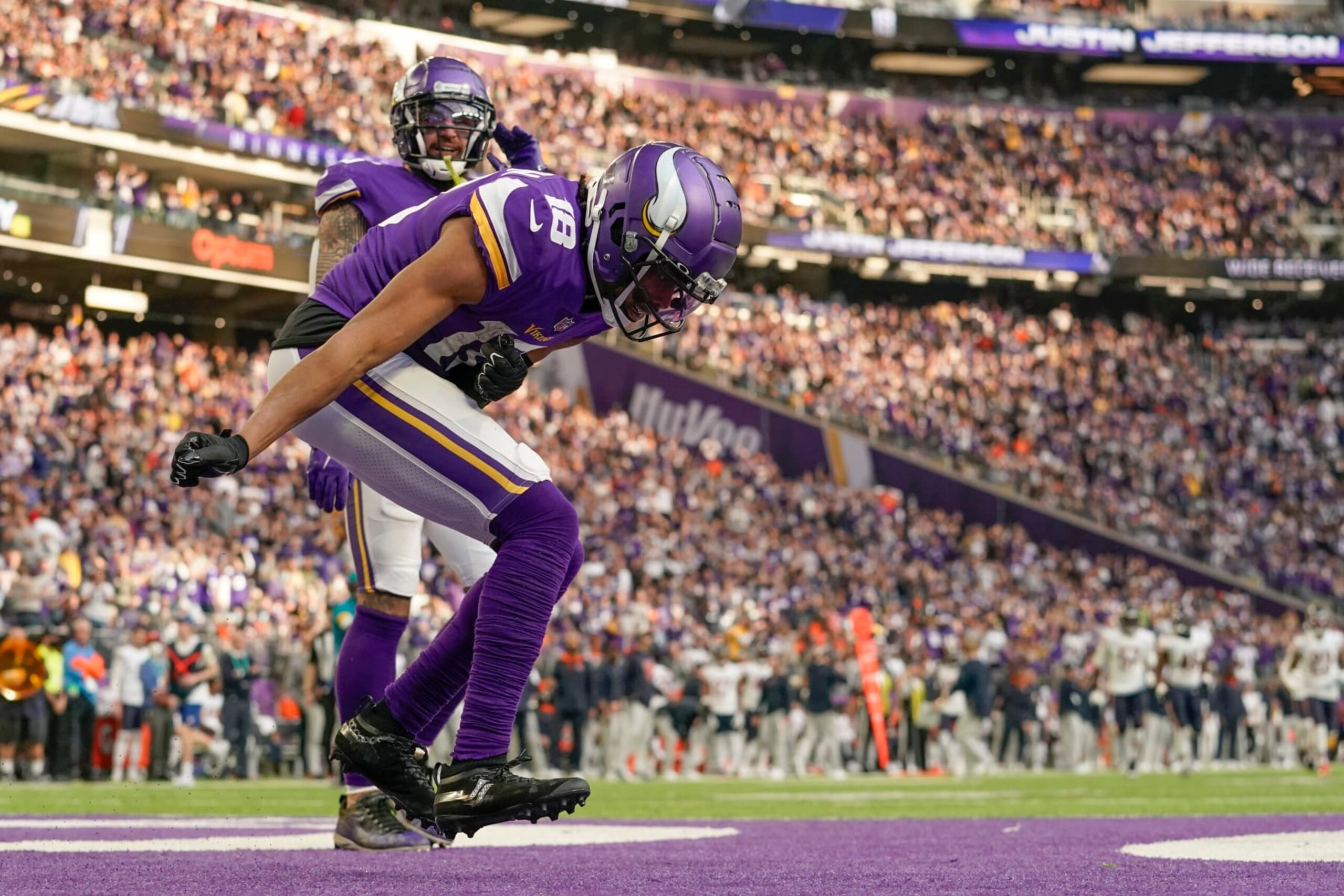 MINNEAPOLIS, MN - JANUARY 09: Minnesota Vikings Wide Receiver Justin Jefferson (18) celebrates his 45-yard touchdown reception from Minnesota Vikings Quarterback Kirk Cousins (8) during a game between the Minnesota Vikings and Chicago Bears on January 9, 2022, at U.S. Bank Stadium in Minneapolis, MN.(Photo by Nick Wosika/Icon Sportswire via Getty Images)