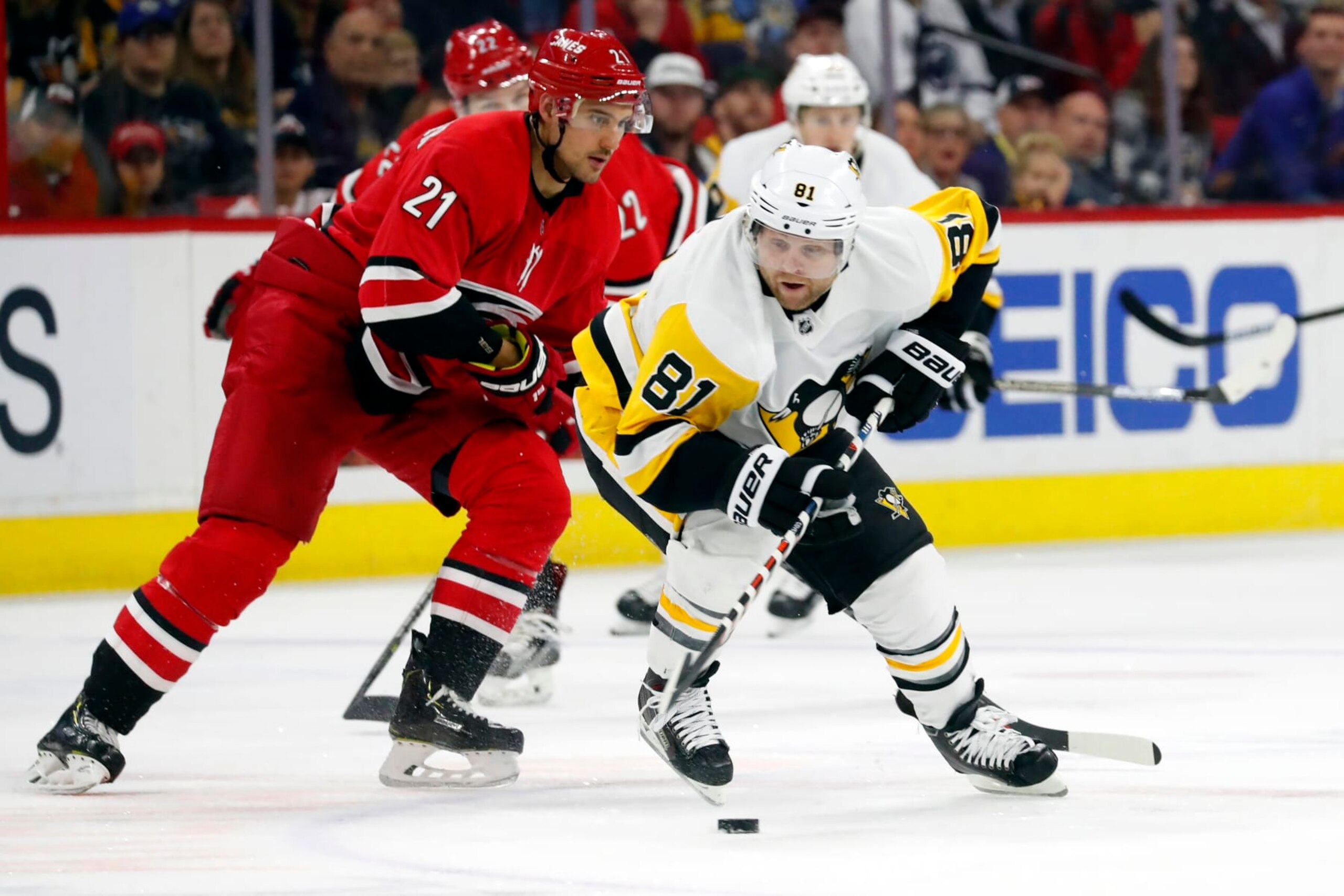 Pittsburgh Penguins' Phil Kessel (81) steals the puck from Carolina Hurricanes' Nino Niederreiter (21) during the second period of an NHL hockey game, Tuesday, March 19, 2019, in Raleigh, N.C. (AP Photo/Karl B DeBlaker)