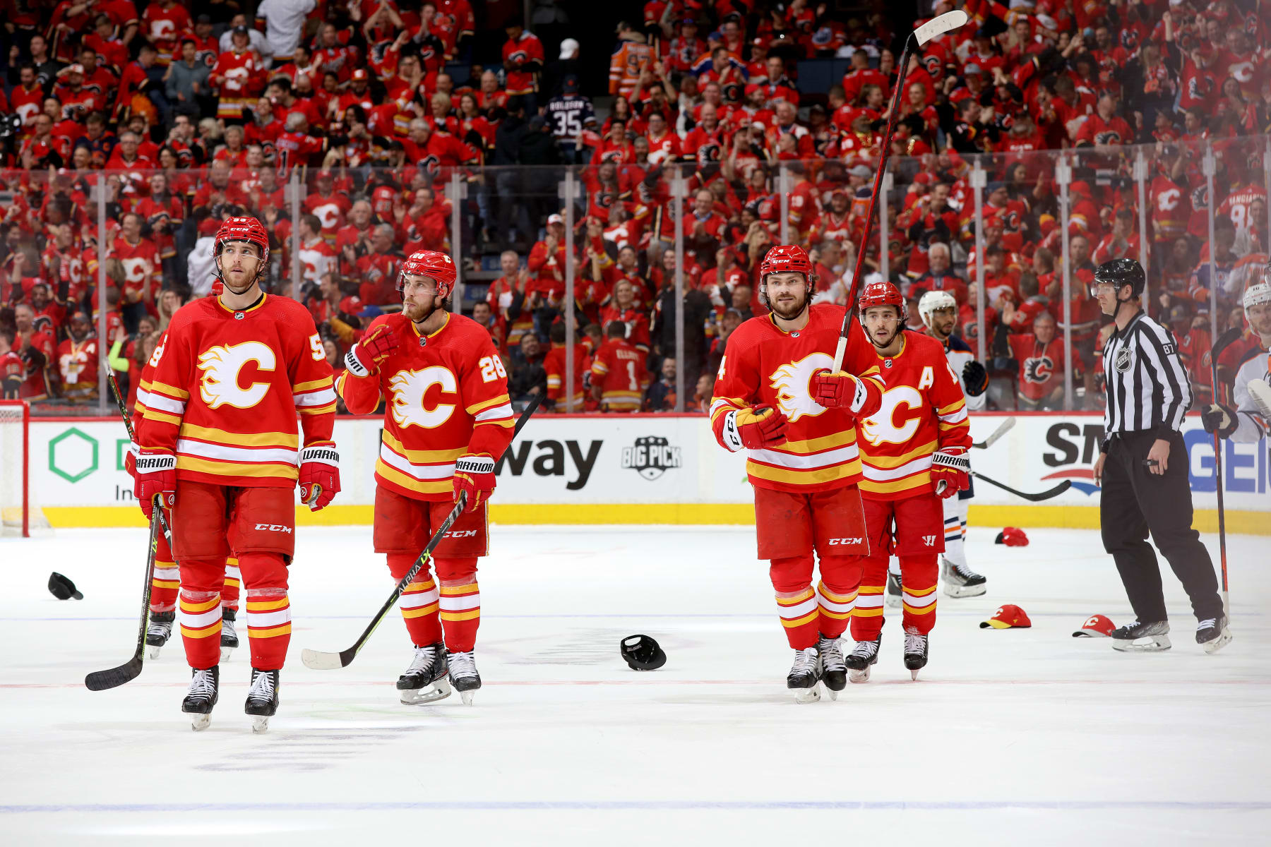 CALGARY, ALBERTA - MAY 18: Johnny Gaudreau #13, Rasmus Andersson #4, and teammates of the Calgary Flames celebrate a goal against the Edmonton Oilers in Game One of the Second Round of the 2022 Stanley Cup Playoffs at Scotiabank Saddledome on May 18, 2022 in Calgary, Alberta. (Photo by Gerry Thomas/NHLI via Getty Images)