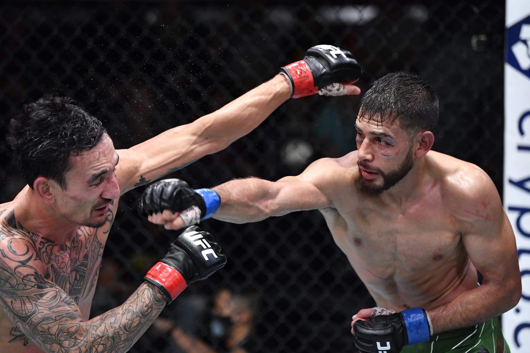 LAS VEGAS, NEVADA - NOVEMBER 13: (R-L) Yair Rodriguez of Mexico punches Max Holloway in a featherweight fight during the UFC Fight Night event at UFC APEX on November 13, 2021 in Las Vegas, Nevada. (Photo by Chris Unger/Zuffa LLC)