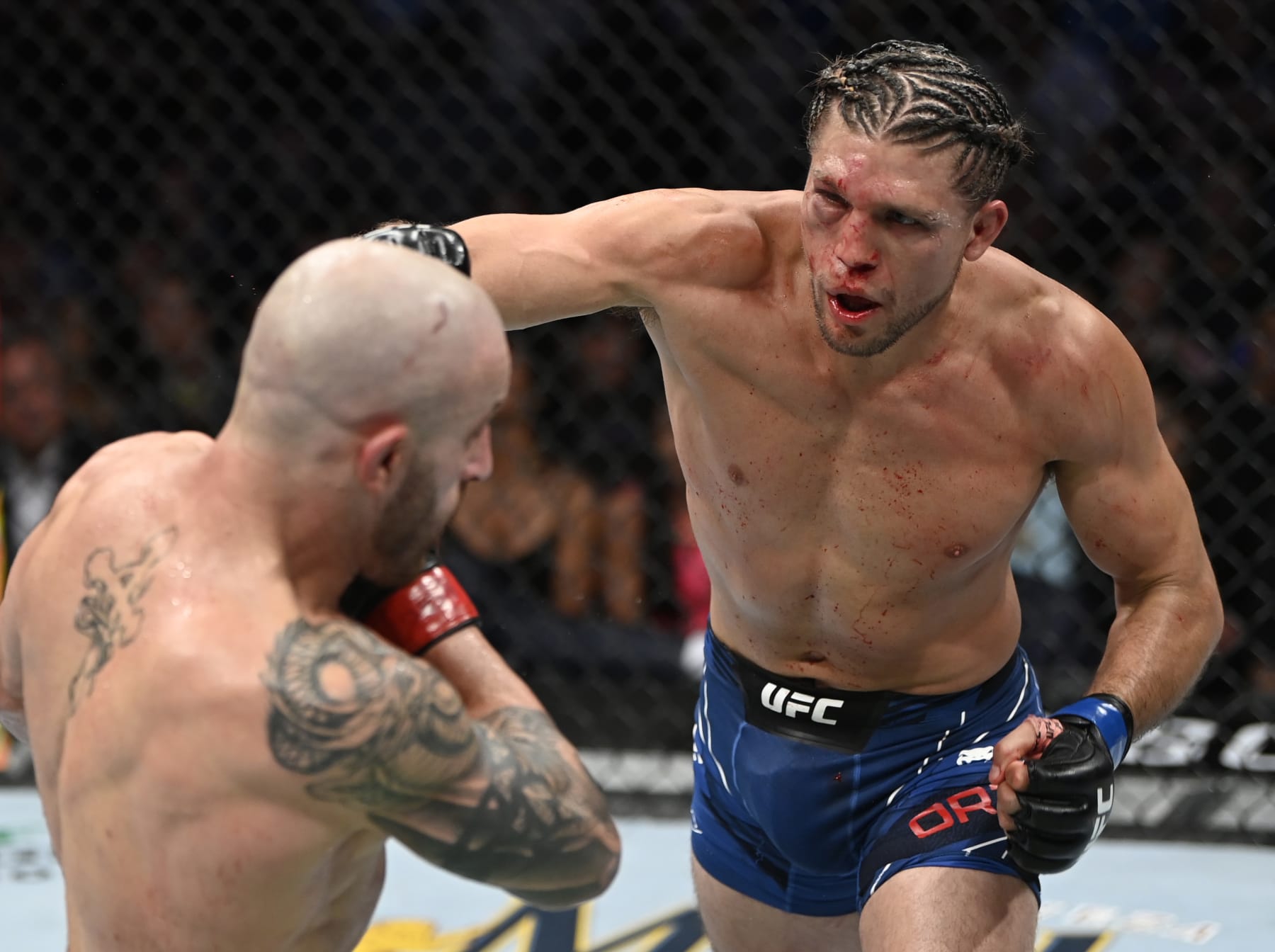 LAS VEGAS, NEVADA - SEPTEMBER 25: (R-L) Brian Ortega punches Alexander Volkanovski of Australia in their UFC featherweight championship fight during the UFC 266 event on September 25, 2021 in Las Vegas, Nevada. (Photo by Jeff Bottari/Zuffa LLC)