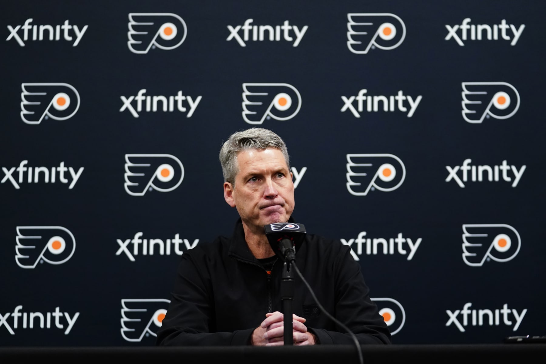 FILE - Philadelphia Flyers General Manager Chuck Fletcher pauses while speaking during a news conference at the team's NHL hockey practice facility in Voorhees, N.J., on Tuesday, Nov. 30, 2021. Before any of the top NHL free agents had signed, Fletcher declared the Flyers were out on them because of “the reality of our cap situation.” (AP Photo/Matt Slocum, File) FILE - Philadelphia Flyers General Manager Chuck Fletcher pauses while speaking during a news conference at the team's NHL hockey practice facility in Voorhees, N.J., on Tuesday, Nov. 30, 2021. Before any of the top NHL free agents had signed, Fletcher declared the Flyers were out on them because of “the reality of our cap situation.” (AP Photo/Matt Slocum, File)