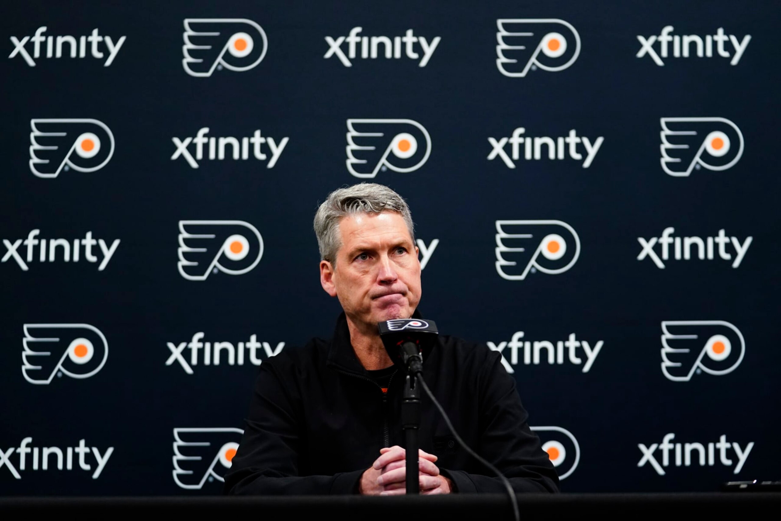FILE - Philadelphia Flyers General Manager Chuck Fletcher pauses while speaking during a news conference at the team's NHL hockey practice facility in Voorhees, N.J., on Tuesday, Nov. 30, 2021. Before any of the top NHL free agents had signed, Fletcher declared the Flyers were out on them because of “the reality of our cap situation.” (AP Photo/Matt Slocum, File)