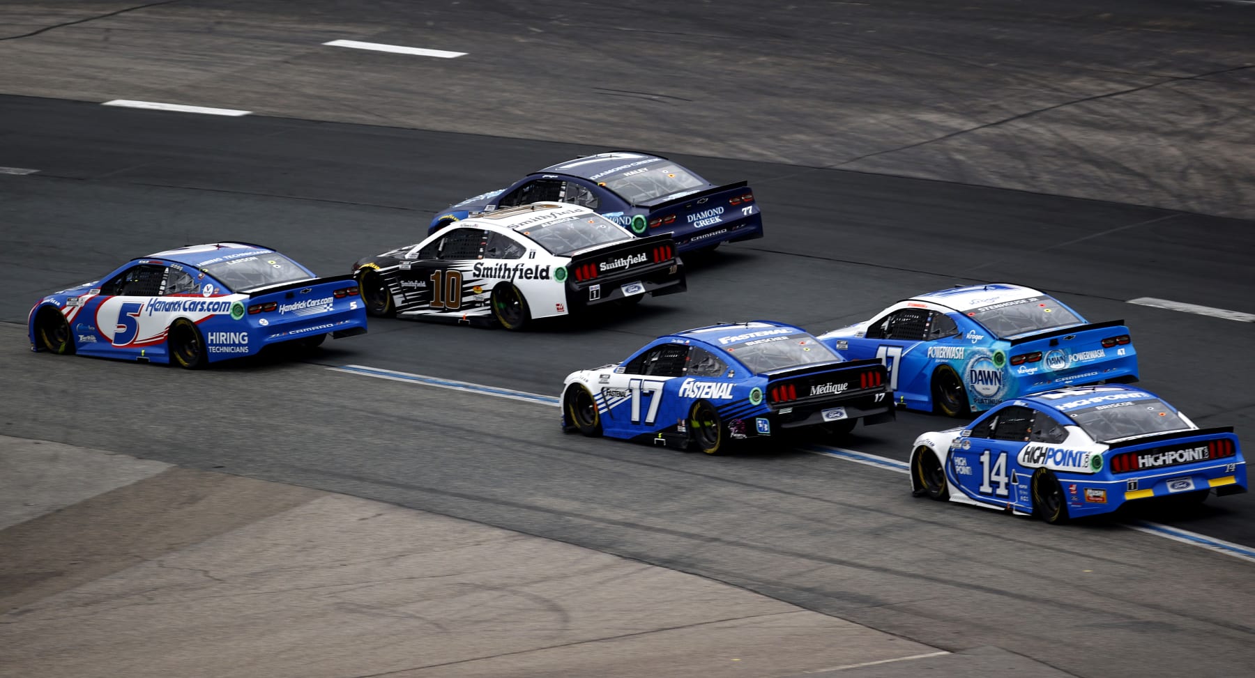 LOUDON, NEW HAMPSHIRE - JULY 18: Kyle Larson, driver of the #5 HendrickCars.com Chevrolet, Aric Almirola, driver of the #10 Smithfield Ford, Chris Buescher, driver of the #17 Fastenal Ford, and Chase Briscoe, driver of the #14 Ford, race during the NASCAR Cup Series Foxwoods Resort Casino 301 at New Hampshire Motor Speedway on July 18, 2021 in Loudon, New Hampshire. (Photo by Jared C. Tilton/Getty Images)