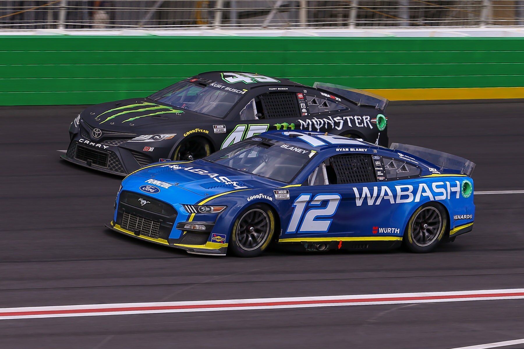 ATLANTA, GA - JULY 10: NASCAR Cup Series driver Ryan Blaney (12) and NASCAR Cup Series driver Kurt Busch (45) race side by side during the Quaker State 400 Presented by Walmart on July 10, 2022 at Atlanta Motor Speedway in Atlanta, GA. (Photo by Chris McDill/Icon Sportswire via Getty Images)