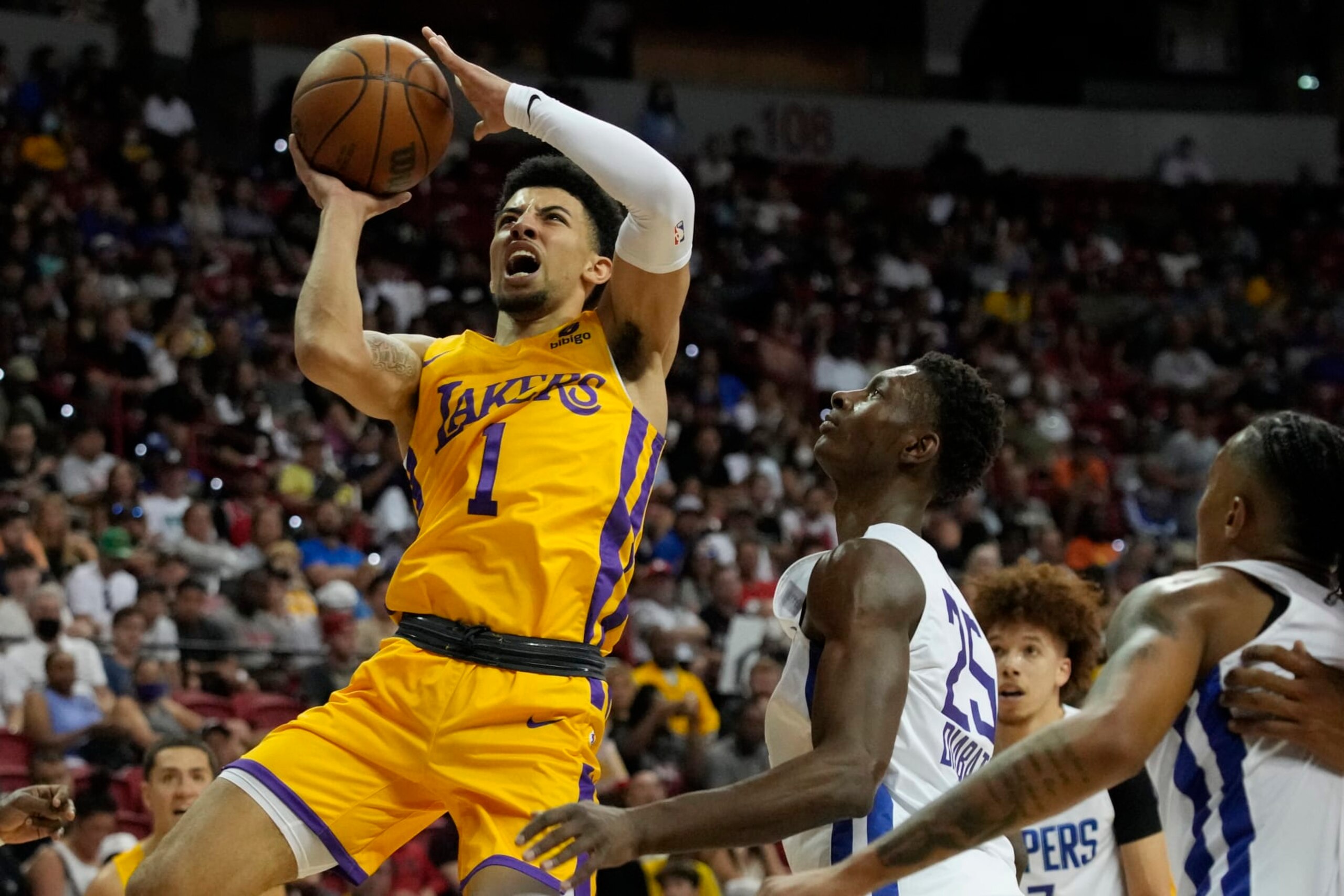 Los Angeles Lakers' Scotty Pippen Jr. shoots over Los Angeles Clippers' Moussa Diabate during the first half an NBA summer league basketball game Tuesday, July 12, 2022, in Las Vegas. (AP Photo/John Locher)