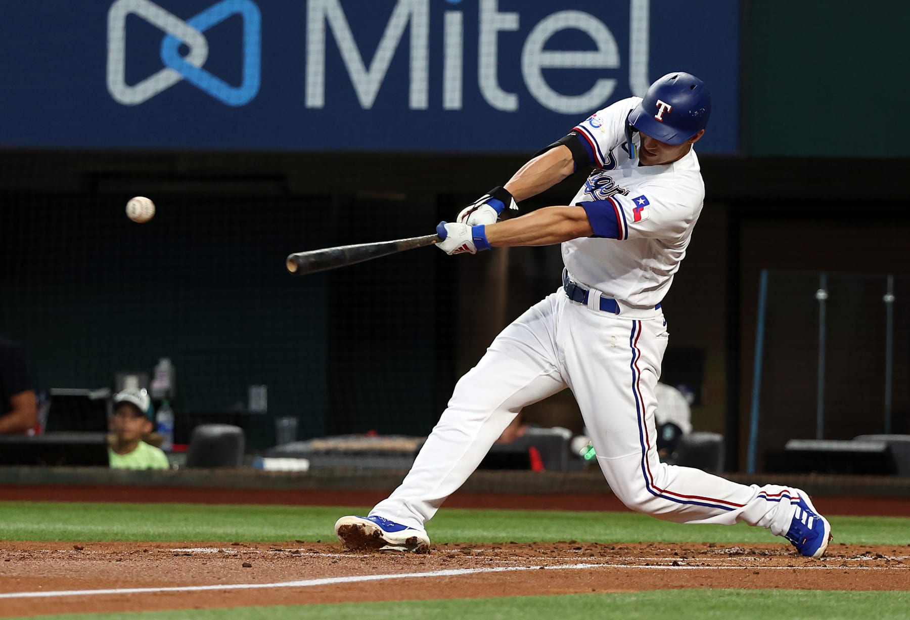 ARLINGTON, TEXAS - JULY 16: Corey Seager #5 of the Texas Rangers hits a single in the first inning against the Seattle Mariners at Globe Life Field on July 16, 2022 in Arlington, Texas. (Photo by Richard Rodriguez/Getty Images)