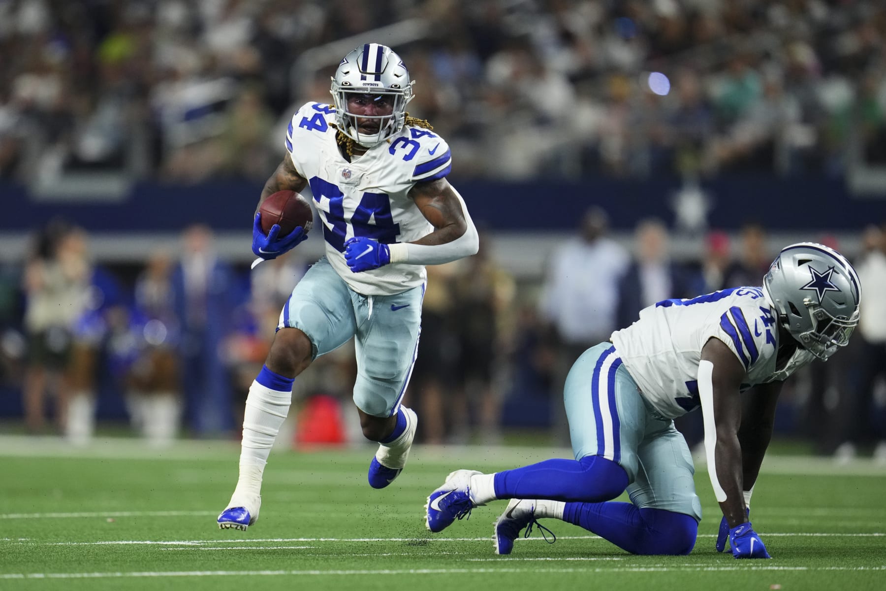 ARLINGTON, TEXAS - AUGUST 21: Rico Dowdle #34 of the Dallas Cowboys runs with the ball during an NFL game against the Houston Texans at AT&T Stadium on August 21, 2021 in Arlington, Texas. (Photo by Cooper Neill/Getty Images)
