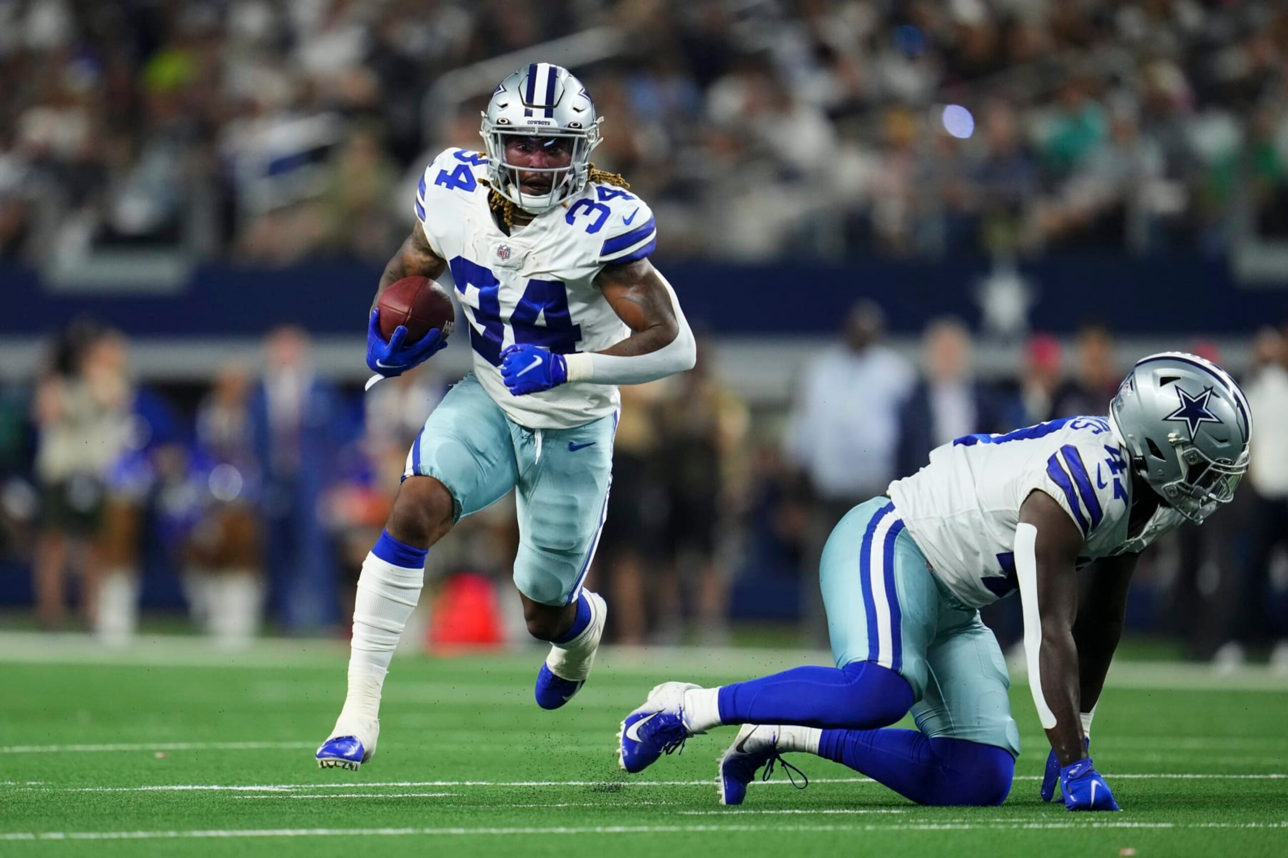 ARLINGTON, TEXAS - AUGUST 21: Rico Dowdle #34 of the Dallas Cowboys runs with the ball during an NFL game against the Houston Texans at AT&T Stadium on August 21, 2021 in Arlington, Texas. (Photo by Cooper Neill/Getty Images)