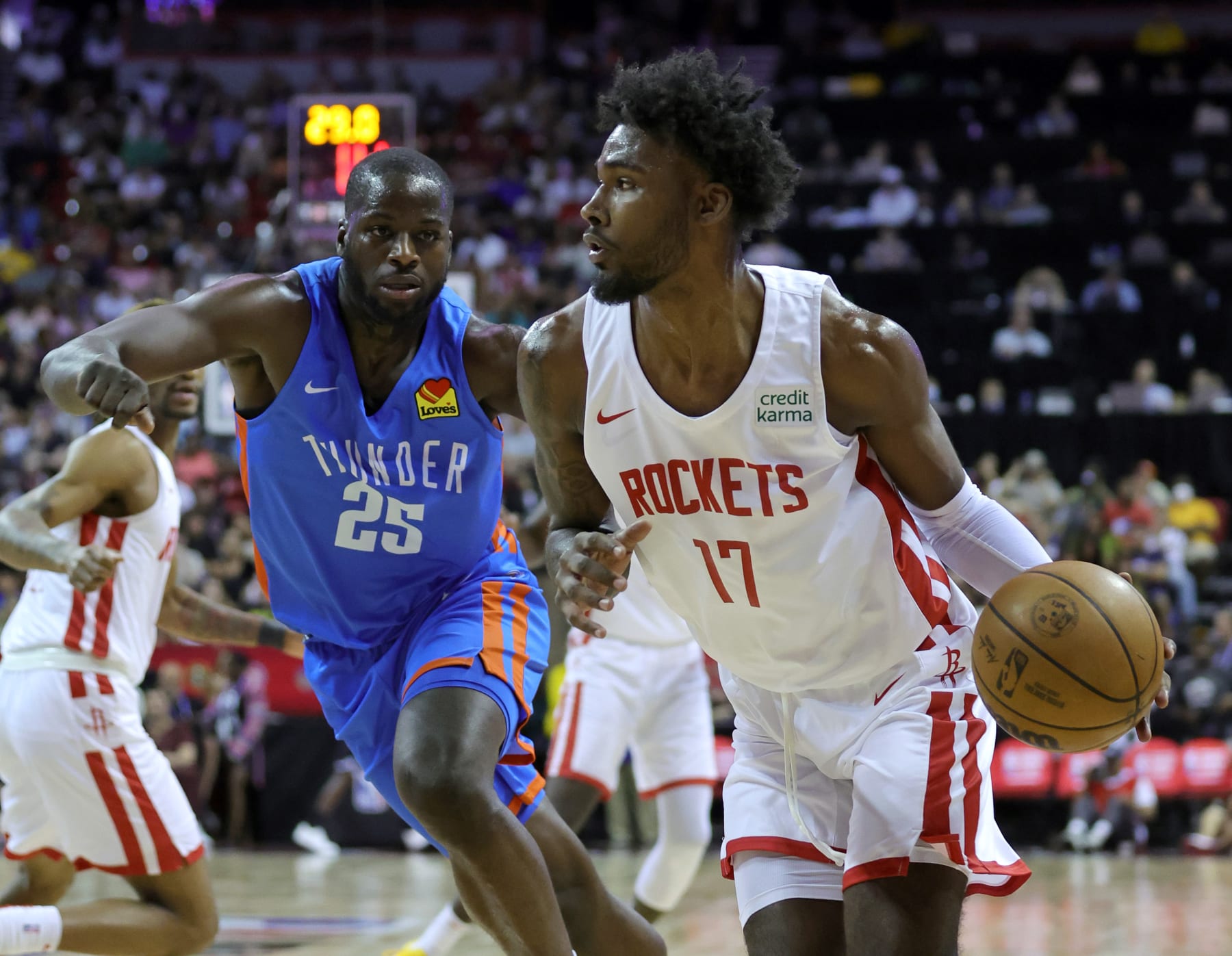 LAS VEGAS, NEVADA - JULY 09: Tari Eason #17 of the Houston Rockets drives against Eugene Omoruyi #25 of the Oklahoma City Thunder during the 2022 NBA Summer League at the Thomas & Mack Center on July 09, 2022 in Las Vegas, Nevada. NOTE TO USER: User expressly acknowledges and agrees that, by downloading and or using this photograph, User is consenting to the terms and conditions of the Getty Images License Agreement. (Photo by Ethan Miller/Getty Images)