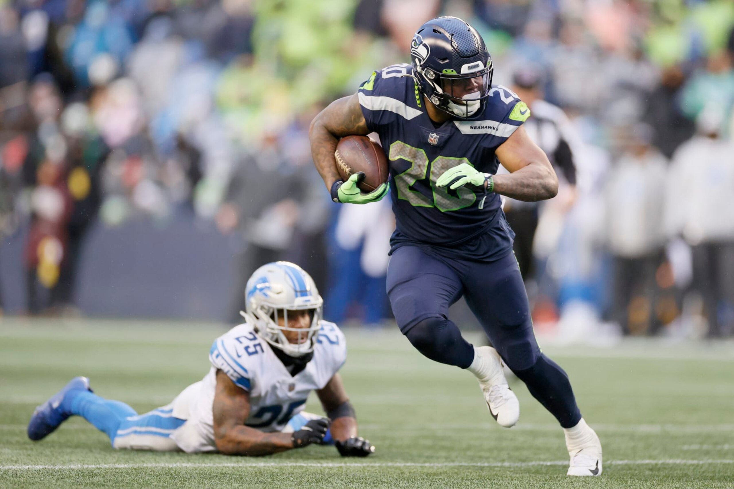 SEATTLE, WASHINGTON - JANUARY 02: Rashaad Penny #20 of the Seattle Seahawks carries the ball against the Detroit Lions during the third quarter at Lumen Field on January 02, 2022 in Seattle, Washington. (Photo by Steph Chambers/Getty Images)