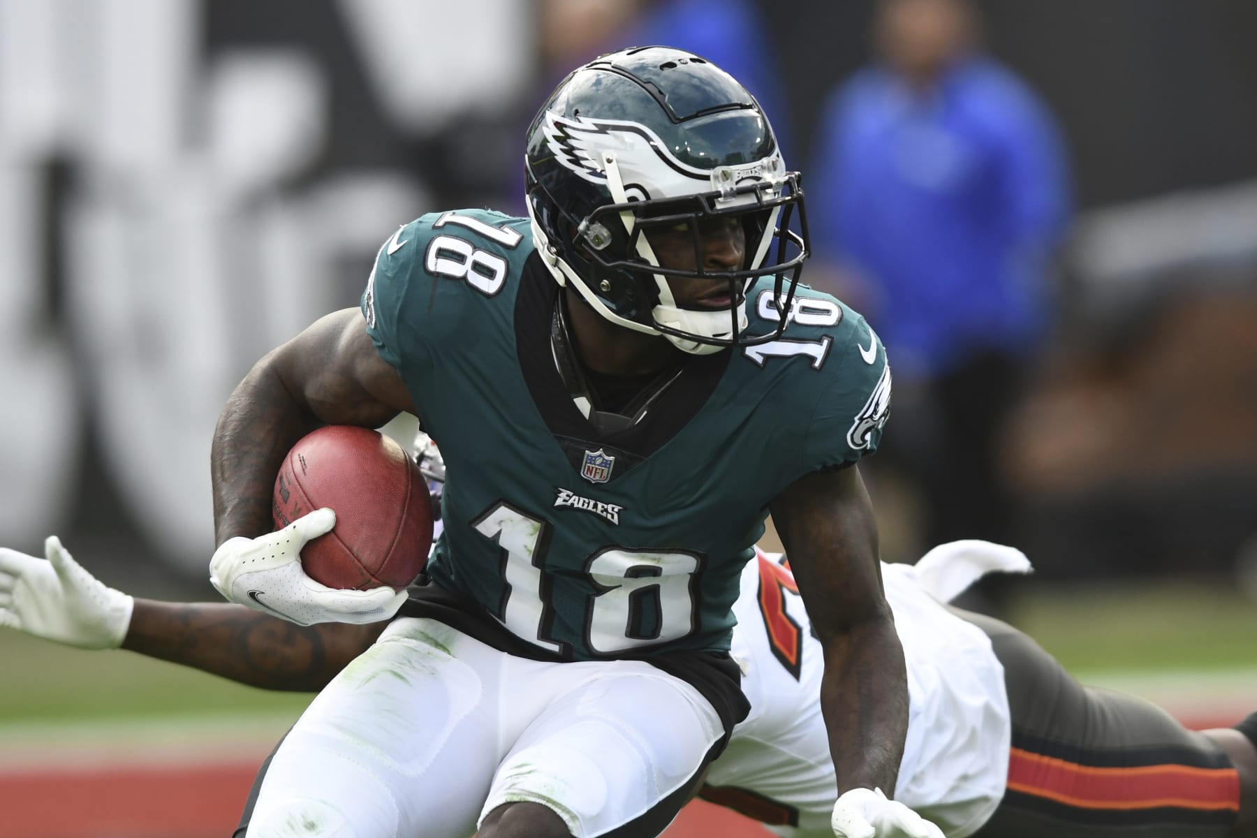 Philadelphia Eagles wide receiver Jalen Reagor (18) eludes a tackle by the Tampa Bay Buccaneers during the second half of an NFL wild-card football game Sunday, Jan. 16, 2022, in Tampa, Fla. (AP Photo/Jason Behnken)