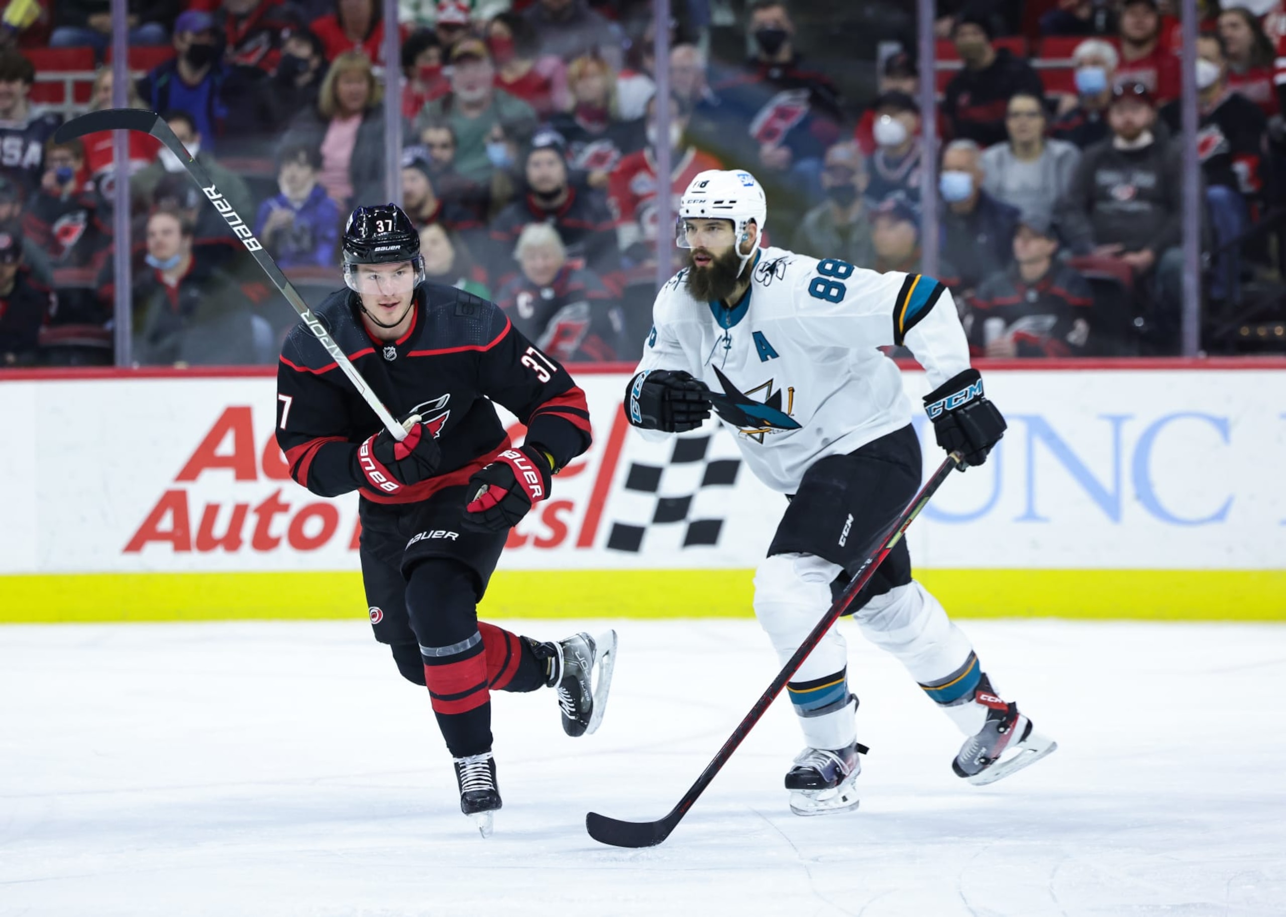 RALEIGH, NC - JANUARY 30: Andrei Svechnikov #37 of the Carolina Hurricanes skates for position on the ice along side of Brent Burns #88 of the San Jose Sharks during an NHL game on January 30, 2022 at PNC Arena in Raleigh, North Carolina. (Photo by Gregg Forwerck/NHLI via Getty Images)