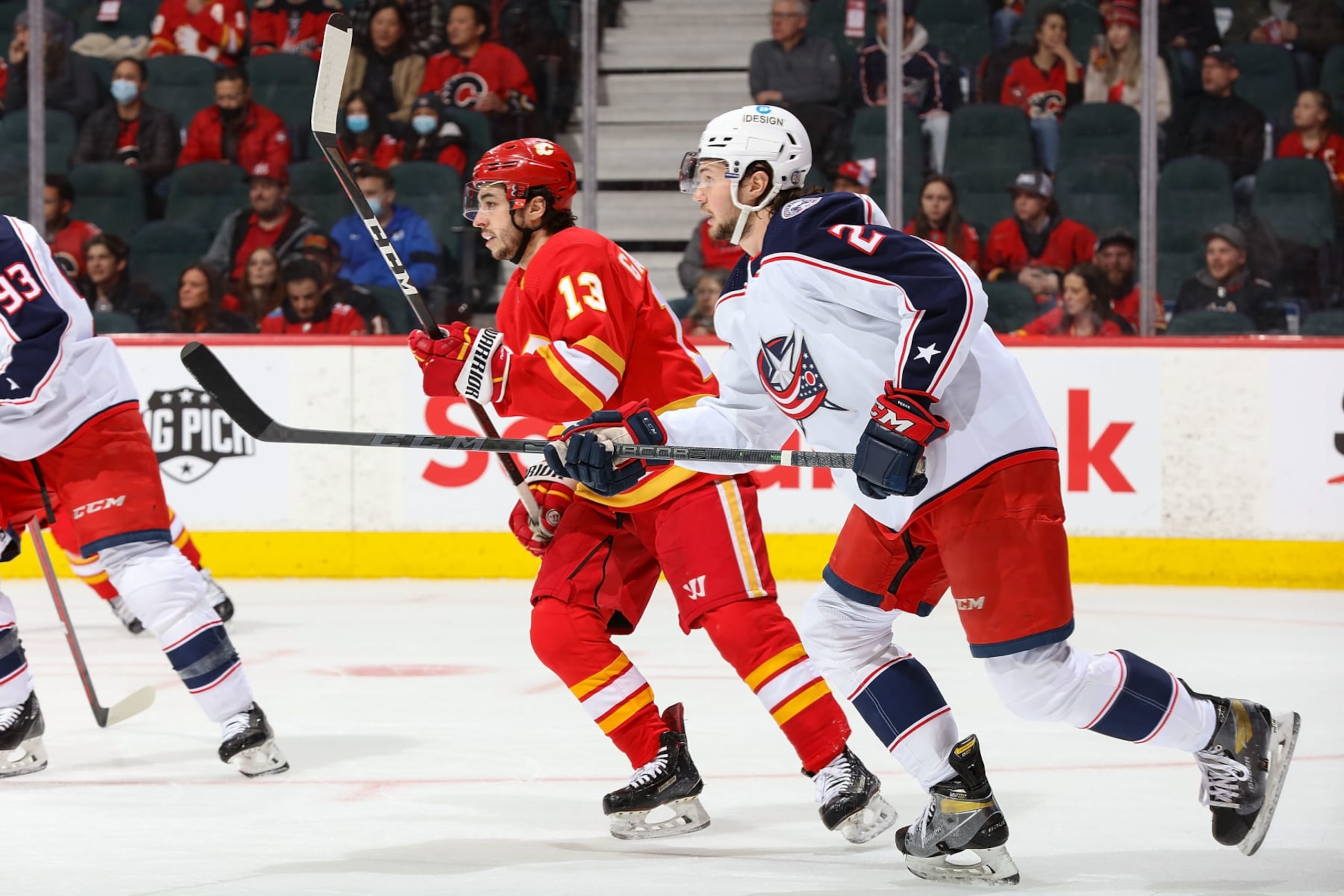 CALGARY, AB - FEBRUARY 15: Johnny Gaudreau #13 of the Calgary Flames skates up ice against Andrew Peeke #2 of the Columbus Blue Jackets at Scotiabank Saddledome on February 15, 2022 in Calgary, Alberta, Canada. (Photo by Gerry Thomas/NHLI via Getty Images)