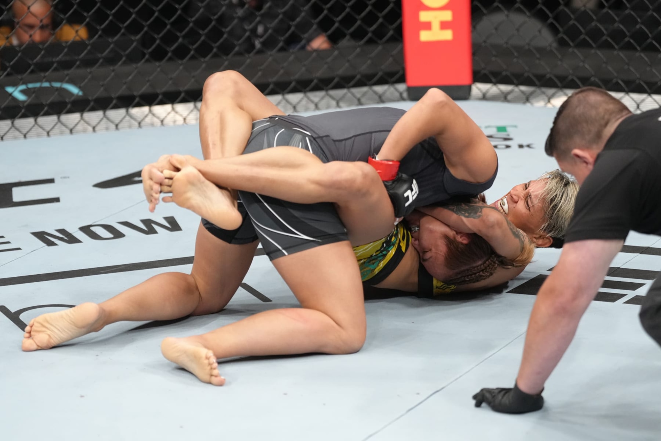 ELMONT, NEW YORK - JULY 16: (R-L) Amanda Lemos of Brazil secures a guillotine choke against Michelle Waterson-Gomez in a strawweight fight during the UFC Fight Night event at UBS Arena on July 16, 2022 in Elmont, New York. (Photo by Jeff Bottari/Zuffa LLC)