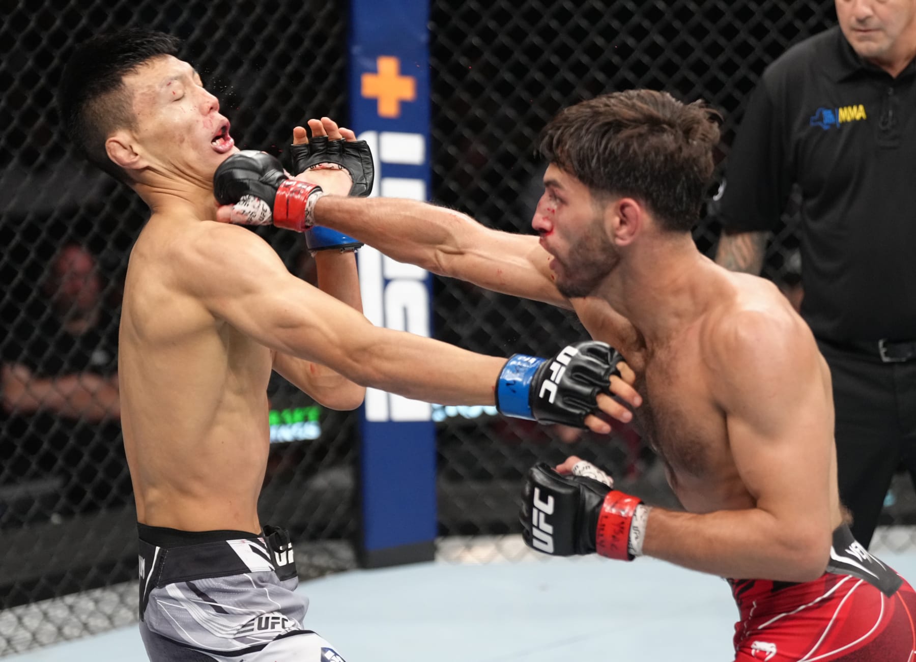 ELMONT, NEW YORK - JULY 16: (R-L) Matt Schnell punches Sumudaerji of China in a flyweight fight during the UFC Fight Night event at UBS Arena on July 16, 2022 in Elmont, New York. (Photo by Jeff Bottari/Zuffa LLC)