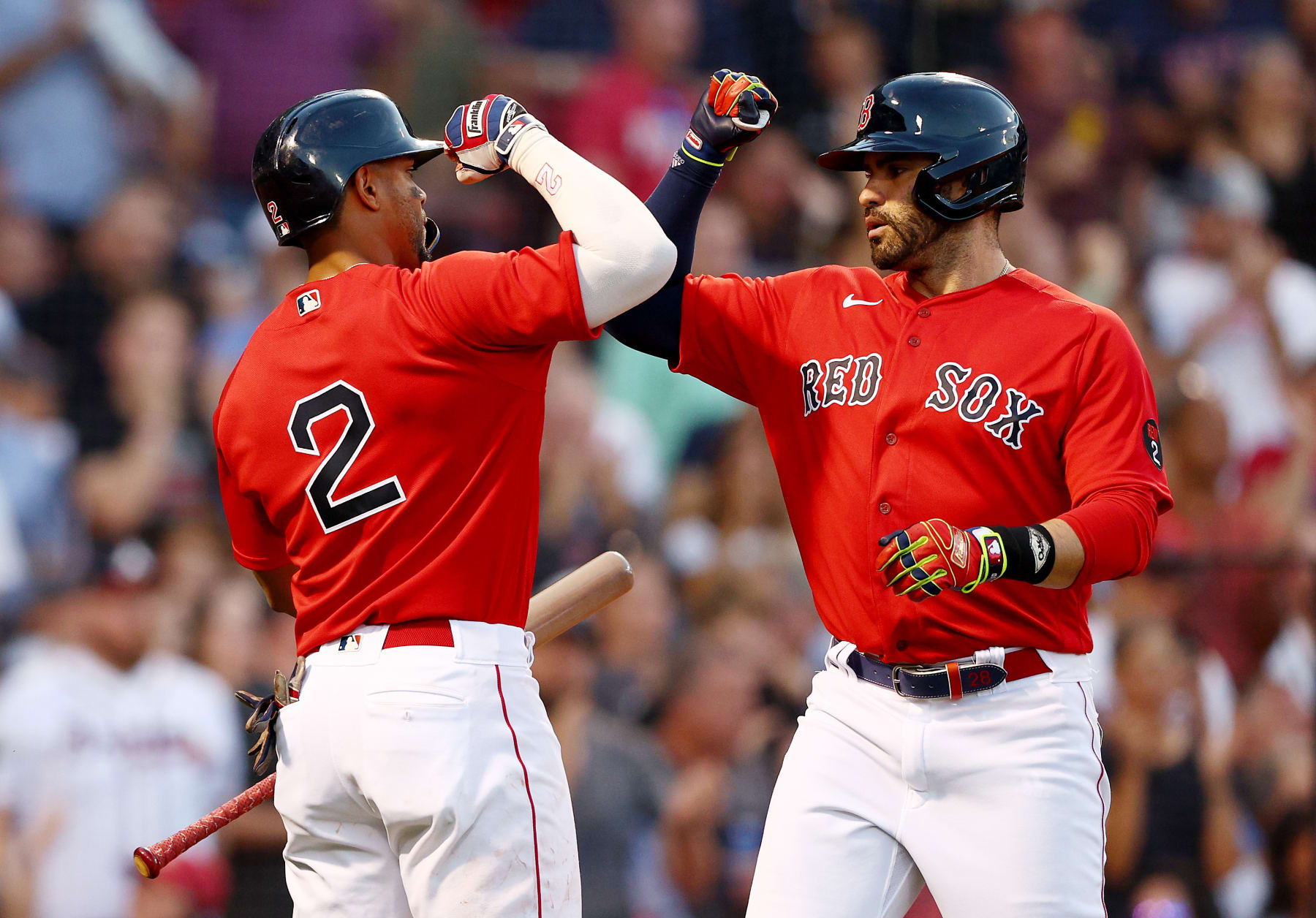 BOSTON, MASSACHUSETTS - JUNE 14:  Xander Bogaerts #2 of the Boston Red Sox congratulates teammate J.D. Martinez #28 after he hit a solo home run in the third inning against the Oakland Athletics at Fenway Park on June 14, 2022 in Boston, Massachusetts. (Photo by Elsa/Getty Images)