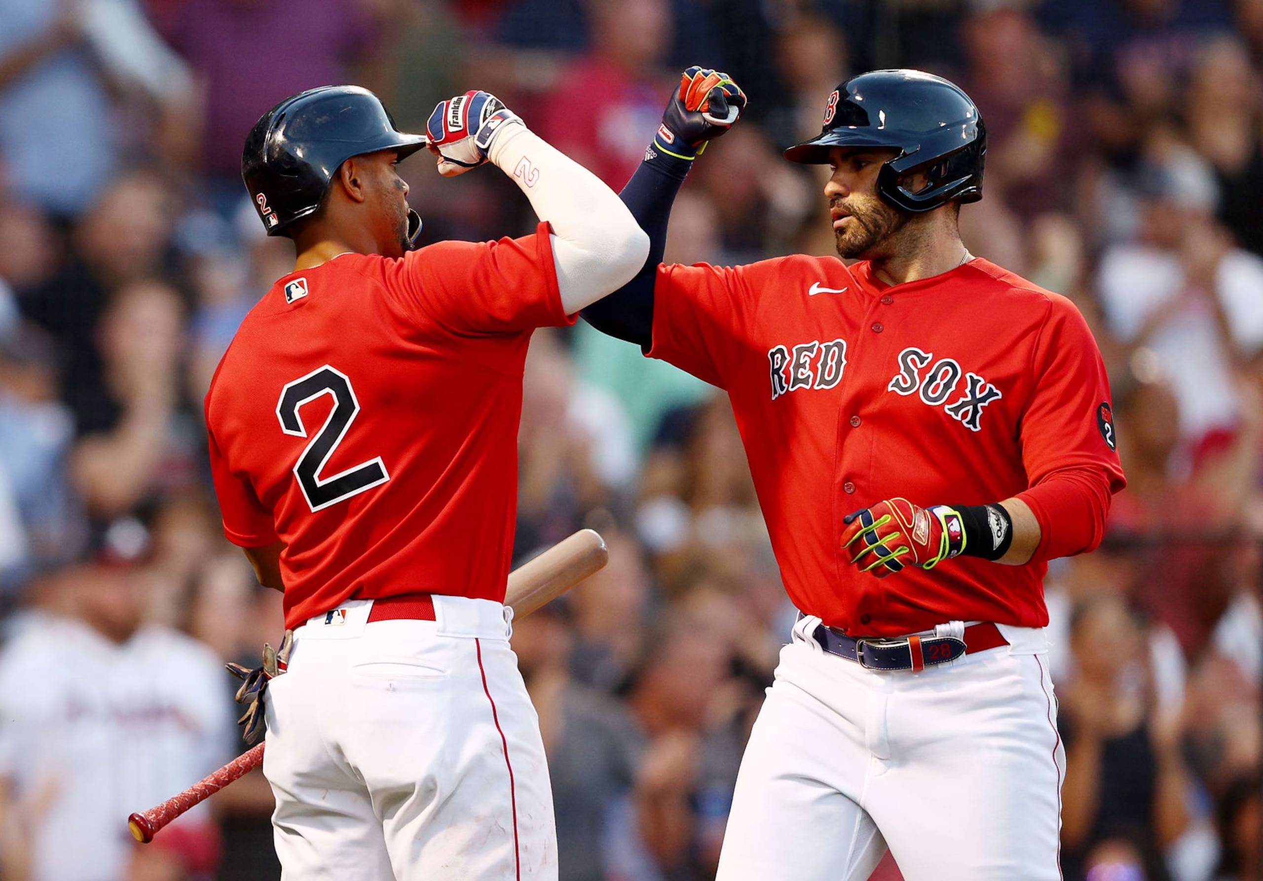BOSTON, MASSACHUSETTS - JUNE 14:  Xander Bogaerts #2 of the Boston Red Sox congratulates teammate J.D. Martinez #28 after he hit a solo home run in the third inning against the Oakland Athletics at Fenway Park on June 14, 2022 in Boston, Massachusetts. (Photo by Elsa/Getty Images)
