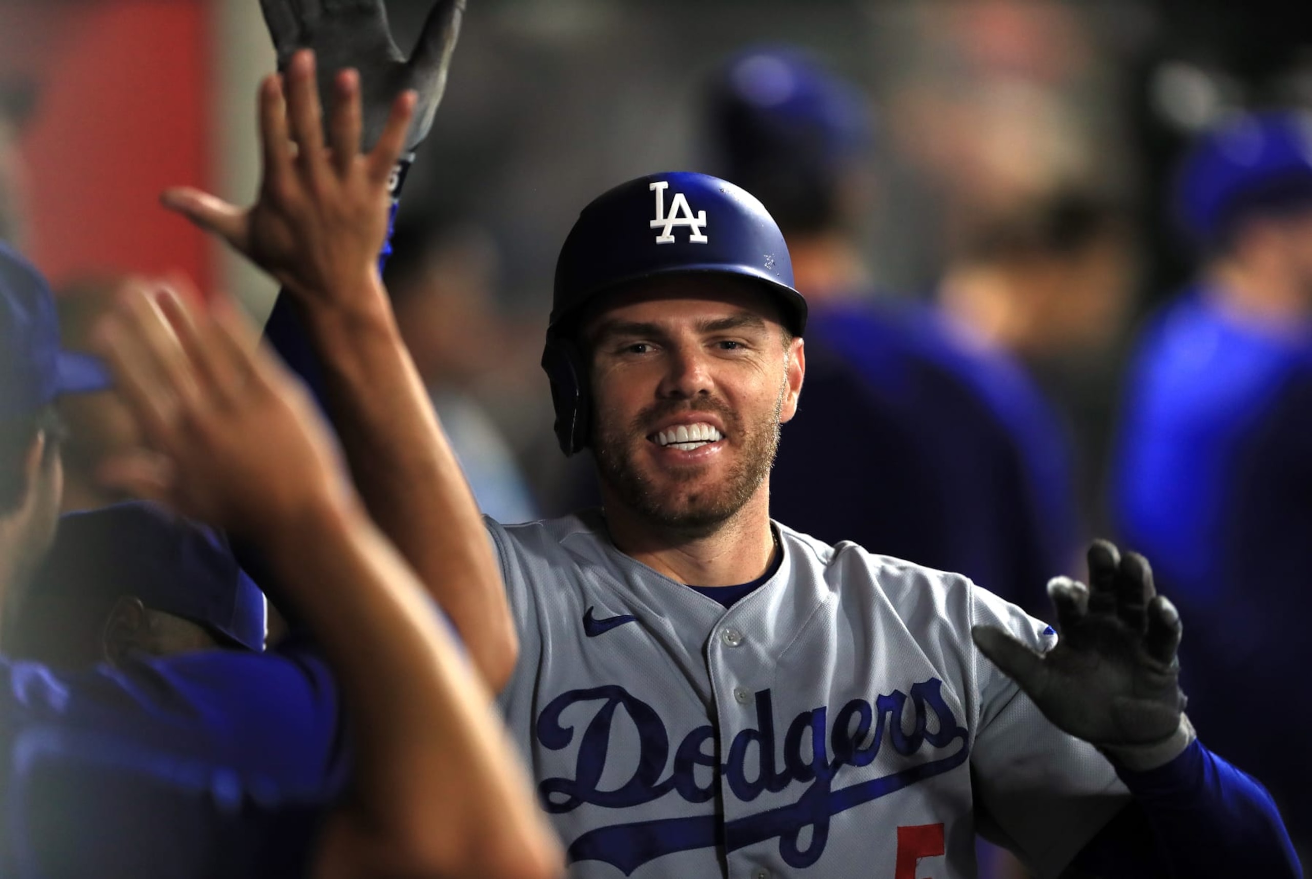 ANAHEIM, CALIFORNIA - JULY 16: Freddie Freeman #5 the Los Angeles Dodgers celebrates in the dugout after hitting a homerun recording his 1000th career RBI in the 5th inning against the Los Angeles Angels  at Angel Stadium of Anaheim on July 16, 2022 in Anaheim, California. (Photo by Kent Horner/Getty Images)