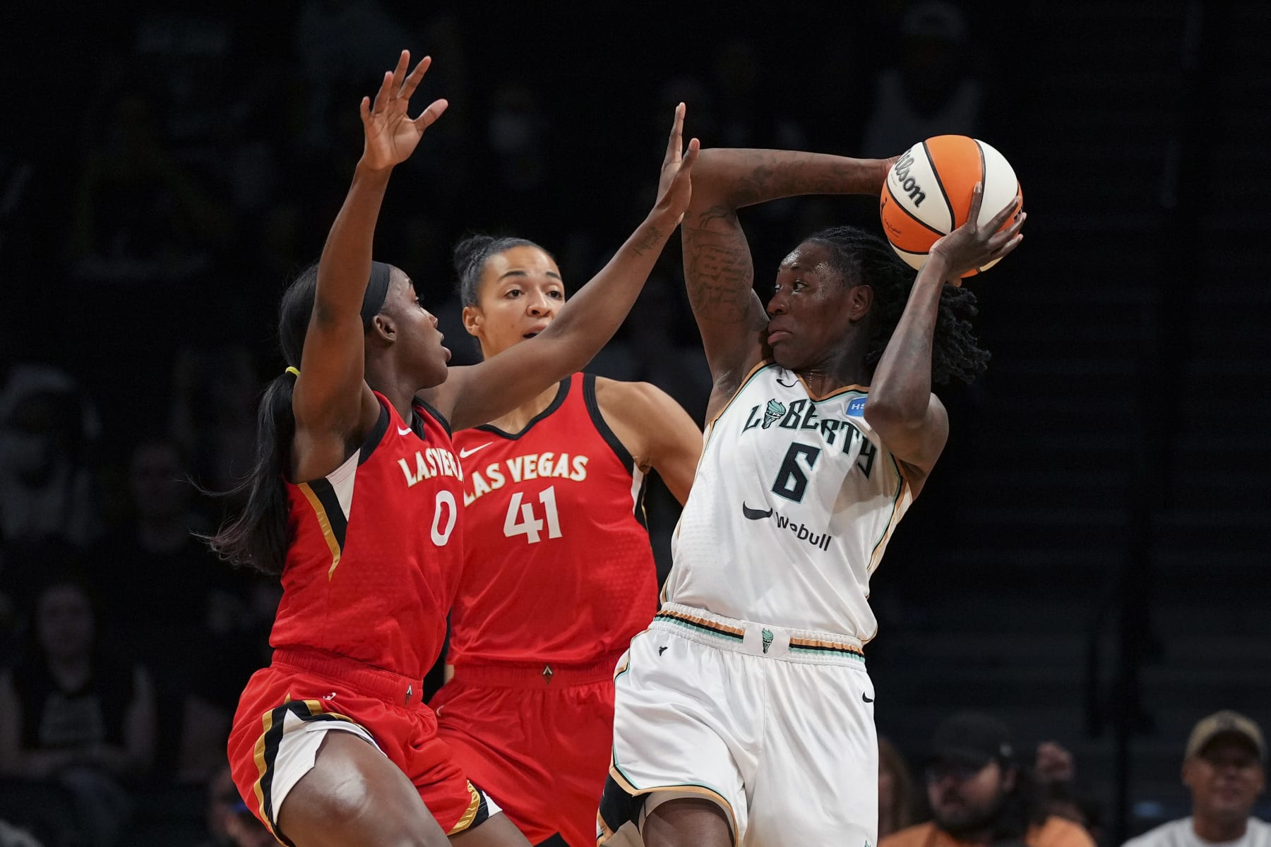 NEW YORK, NY - JULY 12: Natasha Howard #6 of the New York Liberty dribbles the ball against Jackie Young #0 and Kiah Stokes #41 of the Las Vegas Aces at Barclays Center on July 12, 2022 in the Brooklyn borough of New York City. The Las Vegas Aces defeated the New York Liberty 107-101. NOTE TO USER: User expressly acknowledges and agrees that, by downloading and/or using this Photograph, user is consenting to the terms and conditions of the Getty Images License Agreement. (Photo by Mitchell Leff/Getty Images)