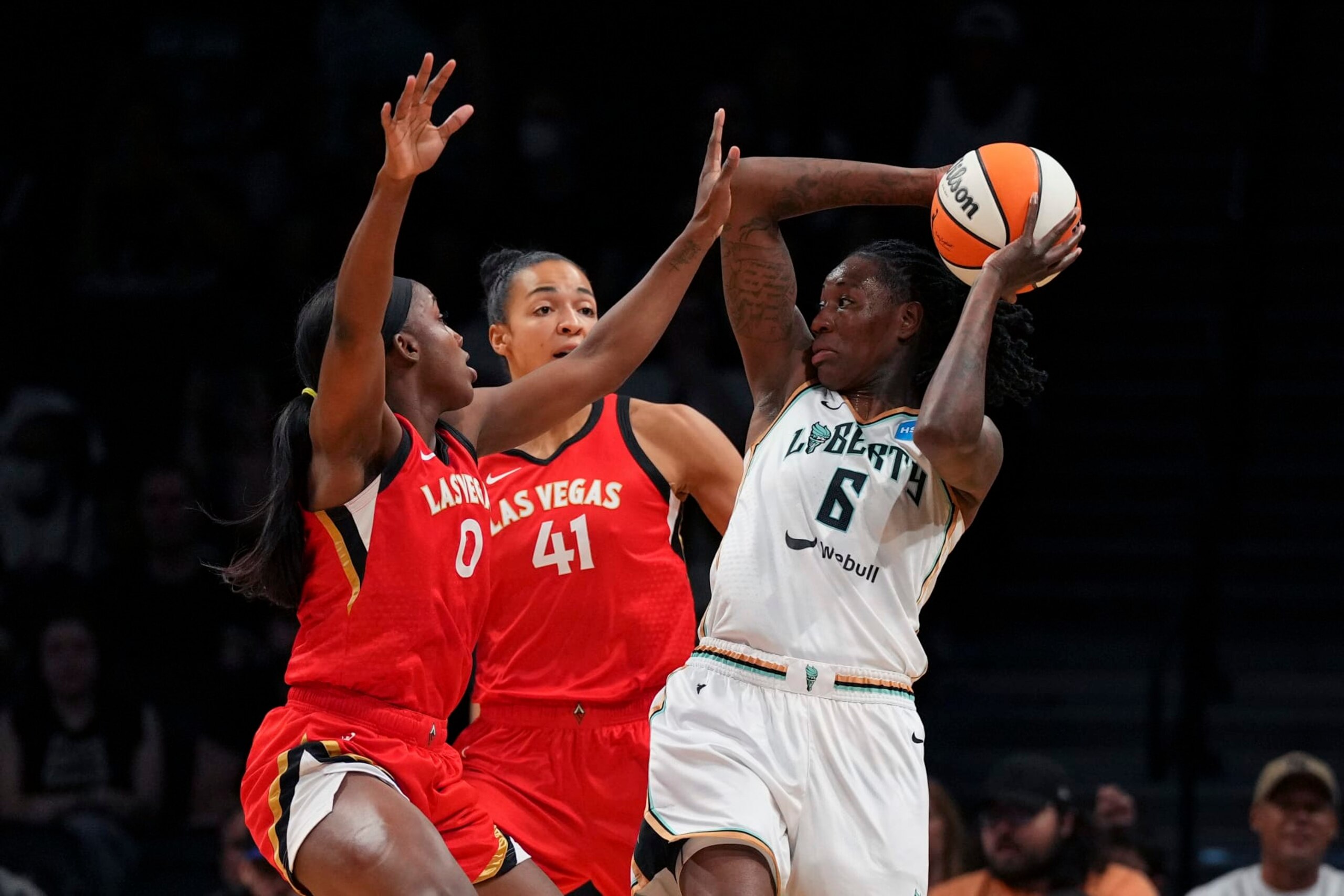 NEW YORK, NY - JULY 12: Natasha Howard #6 of the New York Liberty dribbles the ball against Jackie Young #0 and Kiah Stokes #41 of the Las Vegas Aces at Barclays Center on July 12, 2022 in the Brooklyn borough of New York City. The Las Vegas Aces defeated the New York Liberty 107-101. NOTE TO USER: User expressly acknowledges and agrees that, by downloading and/or using this Photograph, user is consenting to the terms and conditions of the Getty Images License Agreement. (Photo by Mitchell Leff/Getty Images)