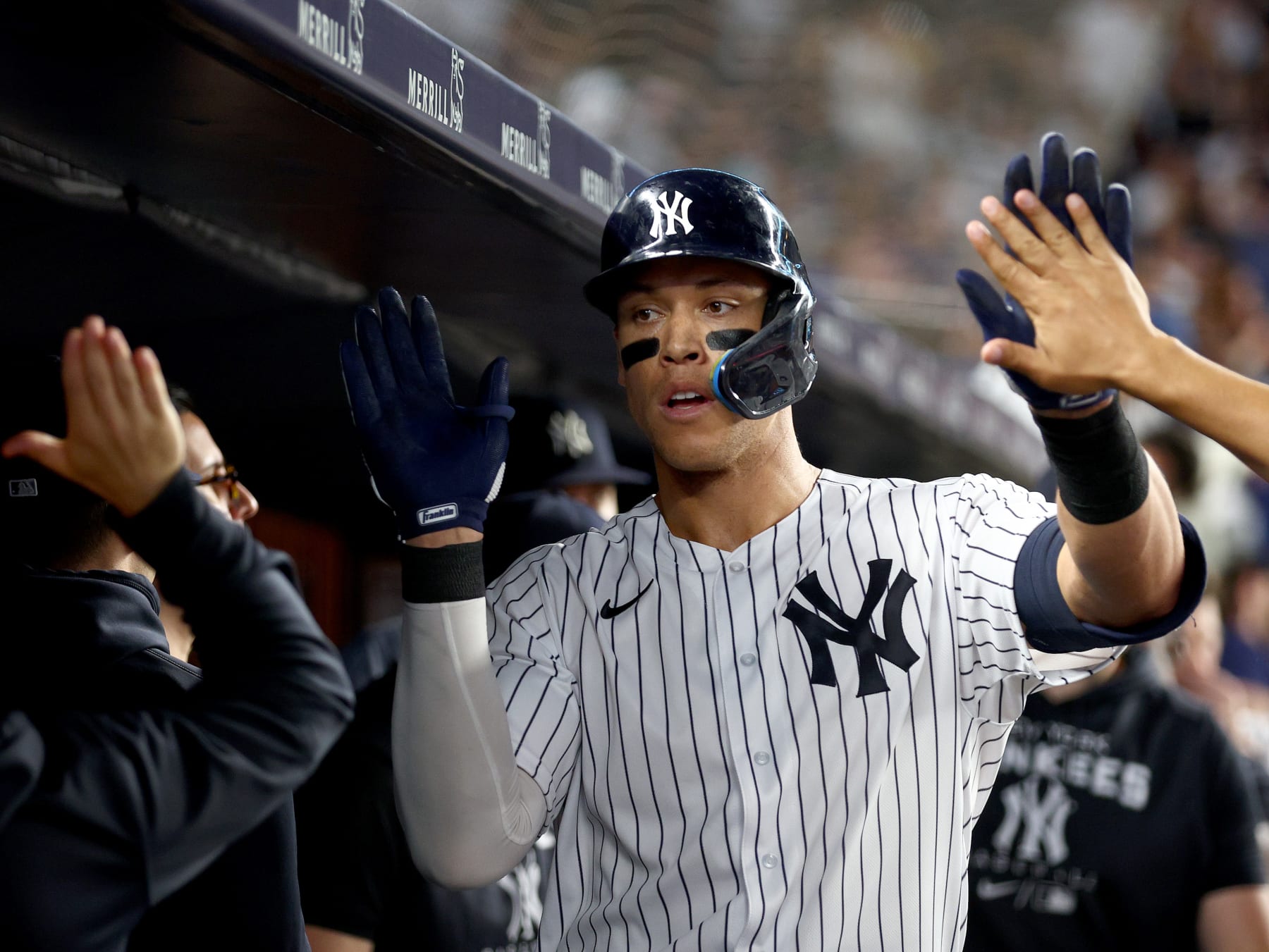 NEW YORK, NEW YORK - JULY 16:  Aaron Judge #99 of the New York Yankees is congratulated by teammates in the dugout after he hit a solo home run in the fifth inning against the Boston Red Sox at Yankee Stadium on July 16, 2022 in the Bronx borough of New York City. (Photo by Elsa/Getty Images)