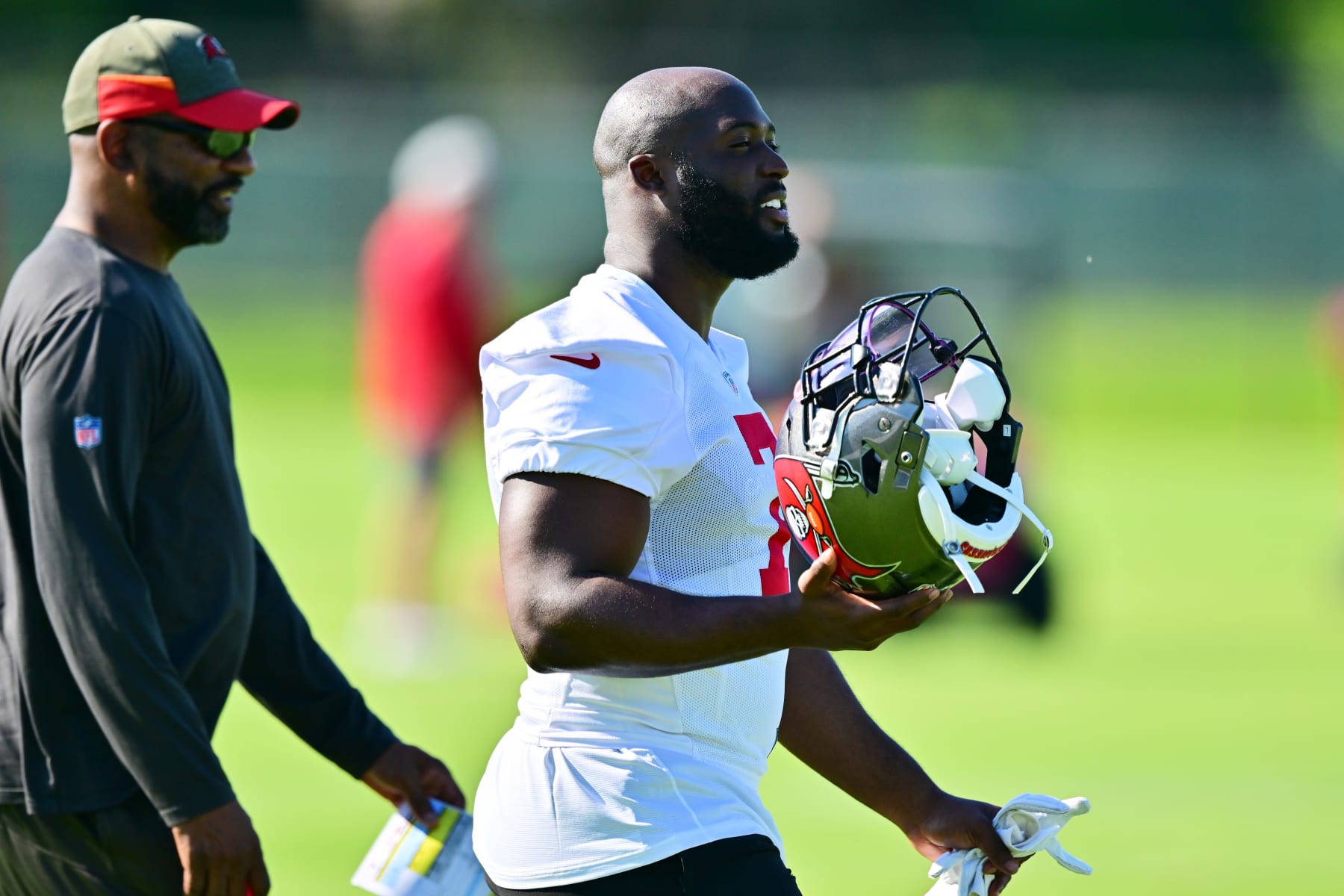 TAMPA, FLORIDA - JUNE 08: Leonard Fournette #7 of Tampa Bay Buccaneers walks with running backs coach Todd McNair during the 2022 Buccaneers minicamp at AdventHealth Training Center on June 08, 2022 in Tampa, Florida. (Photo by Julio Aguilar/Getty Images)
