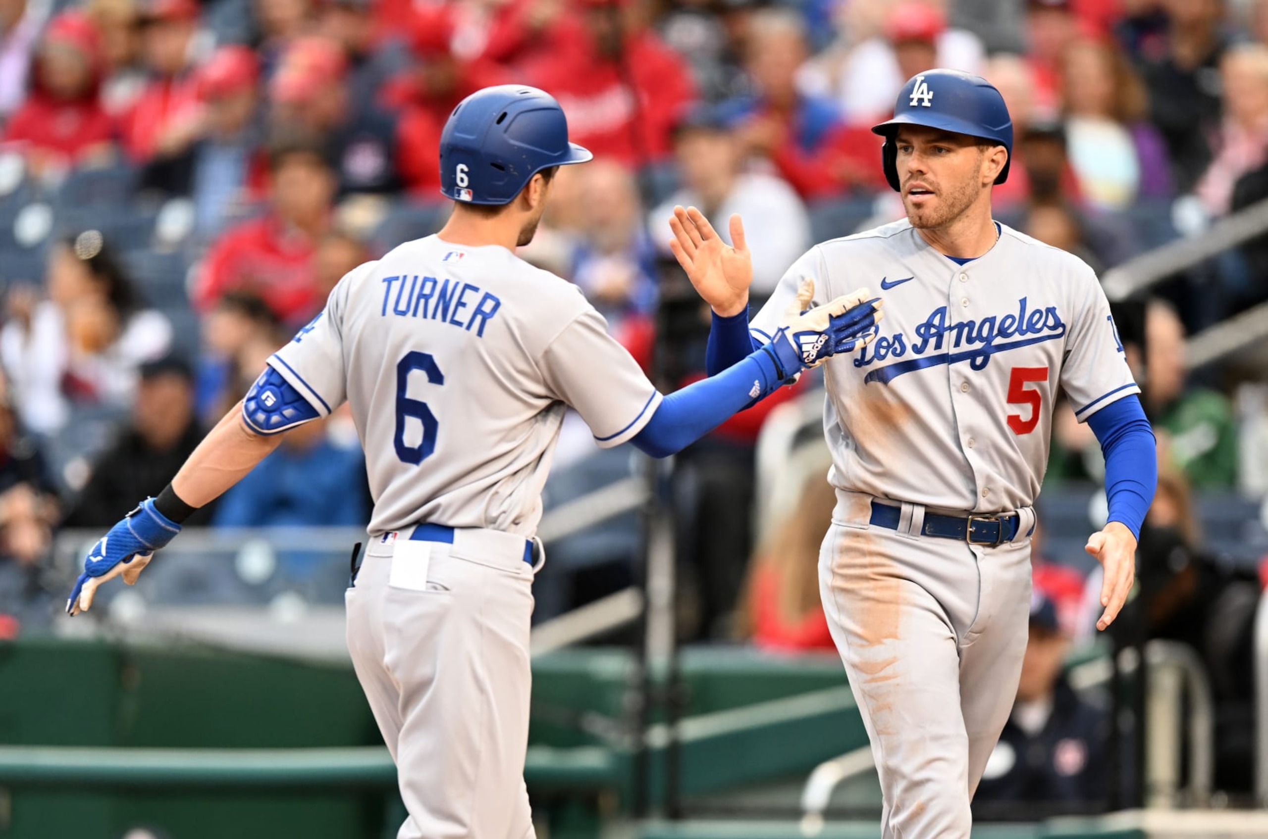 WASHINGTON, DC - MAY 24: Trea Turner #6 of the Los Angeles Dodgers celebrates with Freddie Freeman #5 after hitting a home run against the Washington Nationals at Nationals Park on May 24, 2022 in Washington, DC. (Photo by G Fiume/Getty Images)