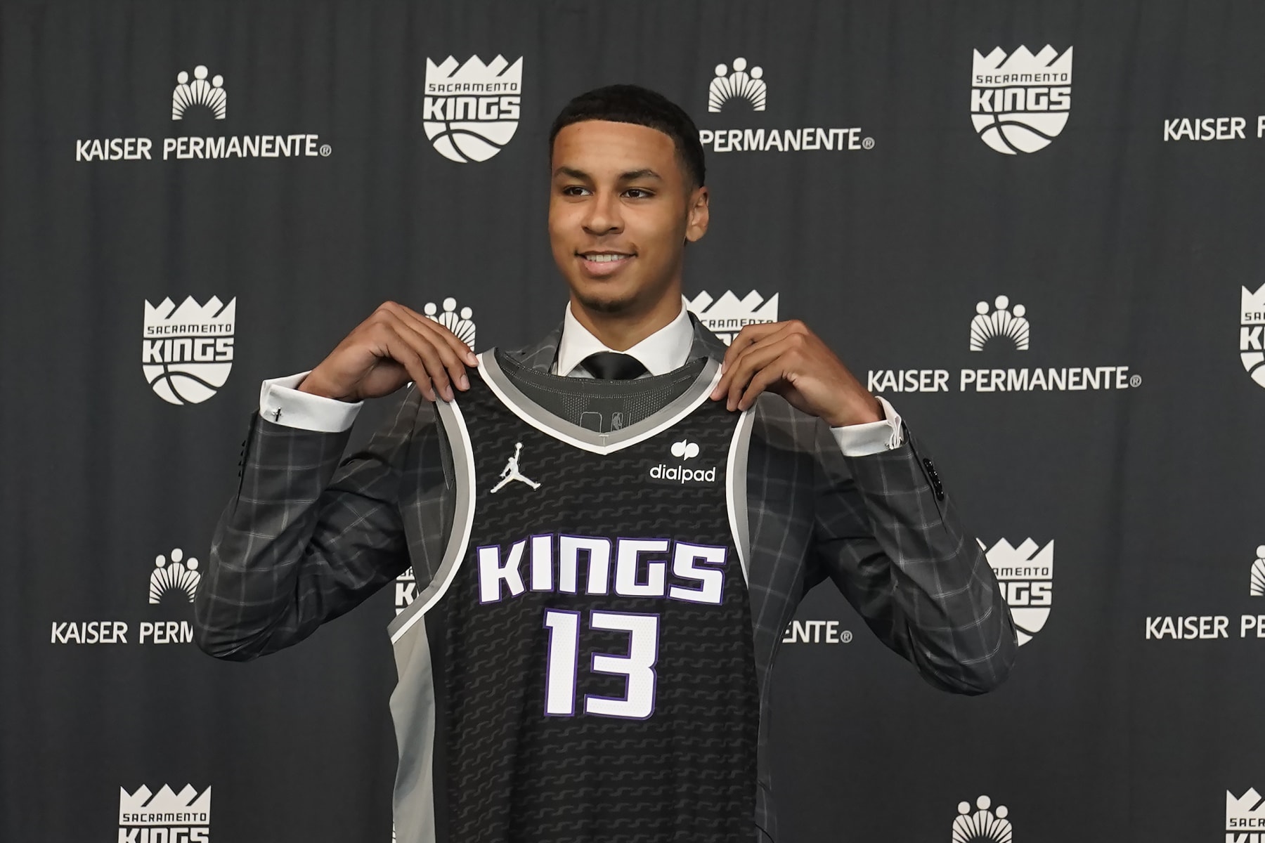 Keegan Murray, selected fourth overall by the Sacramento Kings in the NBA basketball draft, displays a team jersey during a news conference in Sacramento, Calif., Saturday, June 25, 2022. (AP Photo/Rich Pedroncelli)