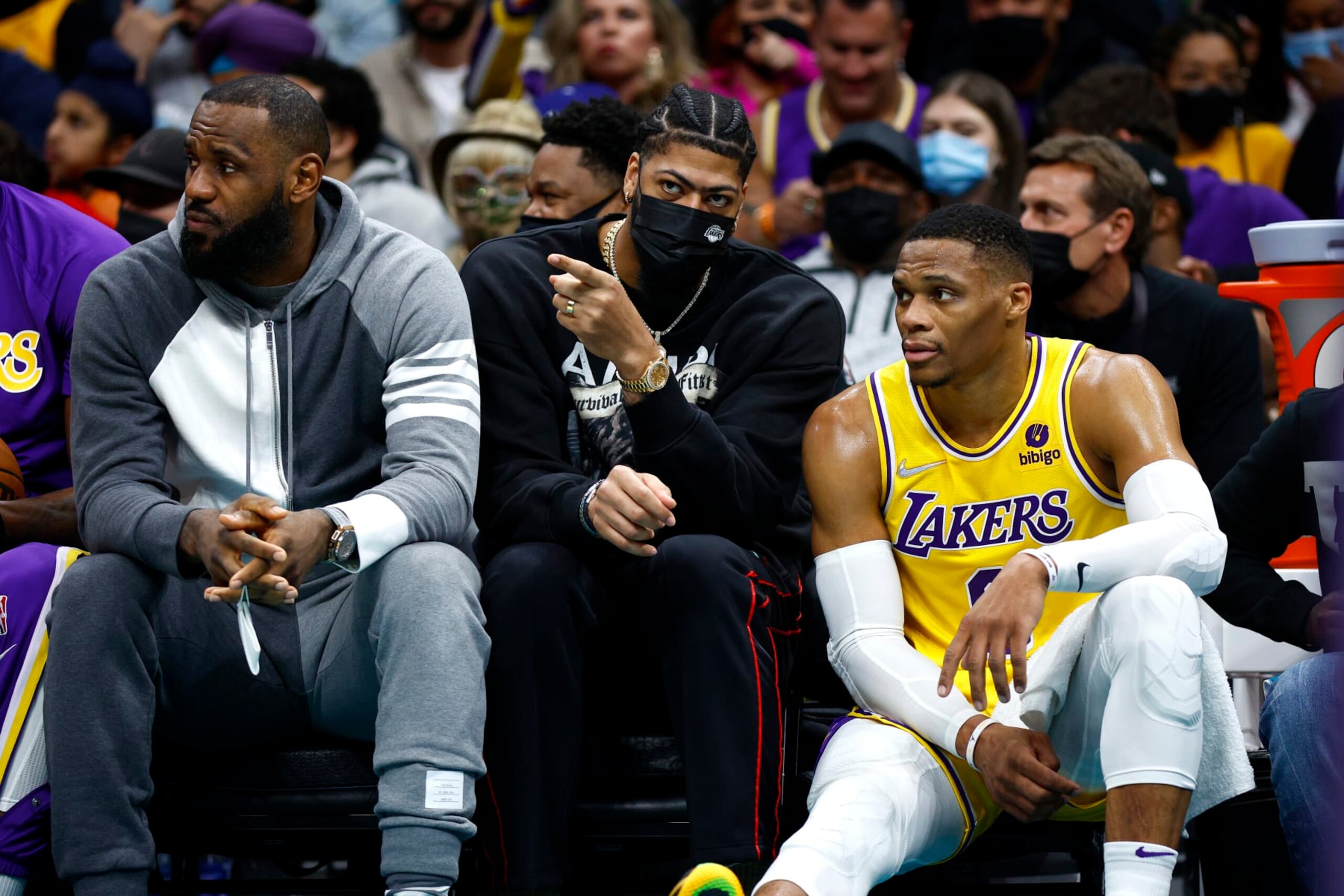 CHARLOTTE, NORTH CAROLINA - JANUARY 28: (L-R)LeBron James #6, Anthony Davis #3, and Russell Westbrook #0 of the Los Angeles Lakers look on from the sideline during the first half of the game against the Charlotte Hornets at Spectrum Center on January 28, 2022 in Charlotte, North Carolina. NOTE TO USER: User expressly acknowledges and agrees that, by downloading and or using this photograph, User is consenting to the terms and conditions of the Getty Images License Agreement. (Photo by Jared C. Tilton/Getty Images)