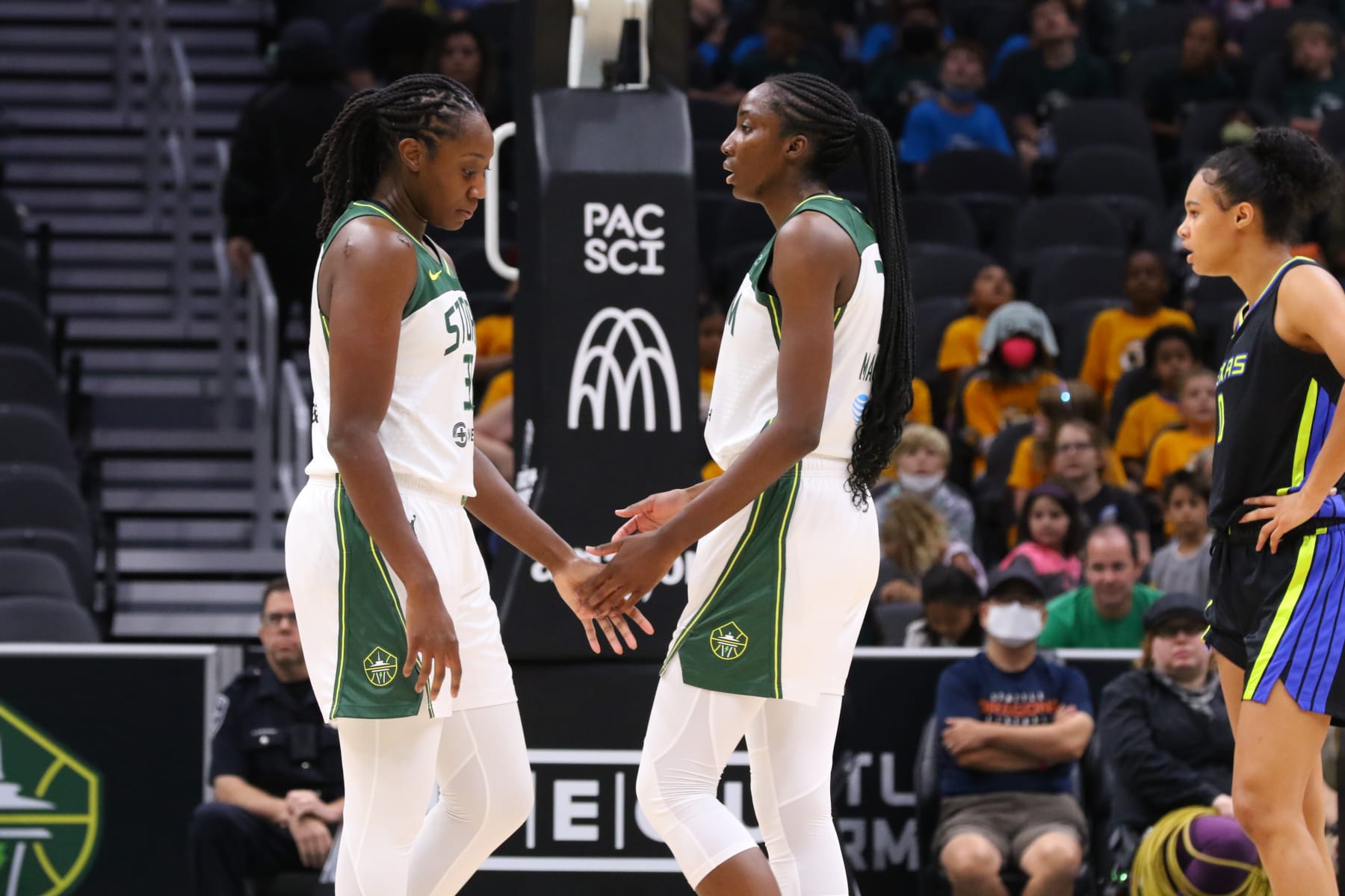SEATTLE, WA - JULY 12: Tina Charles #31 and Ezi Magbegor #13 of the Seattle Storm high five during the game against the Dallas Wings on July 12, 2022 at the Climate Pledge Arena in Seattle, Washington. NOTE TO USER: User expressly acknowledges and agrees that, by downloading and or using this photograph, User is consenting to the terms and conditions of the Getty Images License Agreement. Mandatory Copyright Notice: Copyright 2022 NBAE (Photo by Joshua Huston/NBAE via Getty Images)