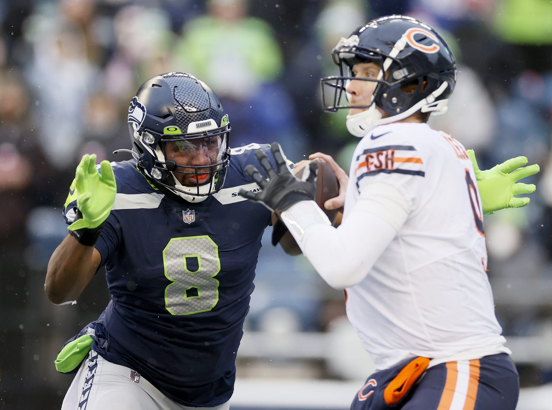 SEATTLE, WASHINGTON - DECEMBER 26: Nick Foles #9 of the Chicago Bears is pressured by Carlos Dunlap #8 of the Seattle Seahawks as he attempts to throw the ball during the third quarter at Lumen Field on December 26, 2021 in Seattle, Washington. (Photo by Steph Chambers/Getty Images)