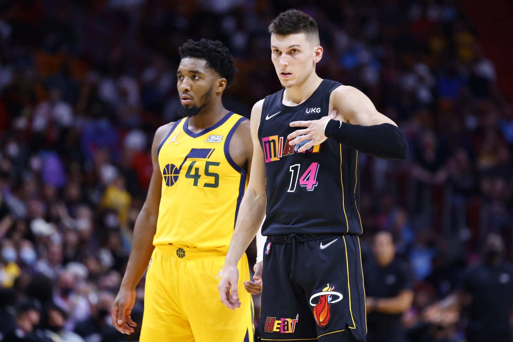 MIAMI, FLORIDA - NOVEMBER 06: Donovan Mitchell #45 of the Utah Jazz and Tyler Herro #14 of the Miami Heat look on during the fourth quarter at FTX Arena on November 06, 2021 in Miami, Florida. NOTE TO USER: User expressly acknowledges and agrees that, by downloading and or using this photograph, User is consenting to the terms and conditions of the Getty Images License Agreement. (Photo by Michael Reaves/Getty Images)