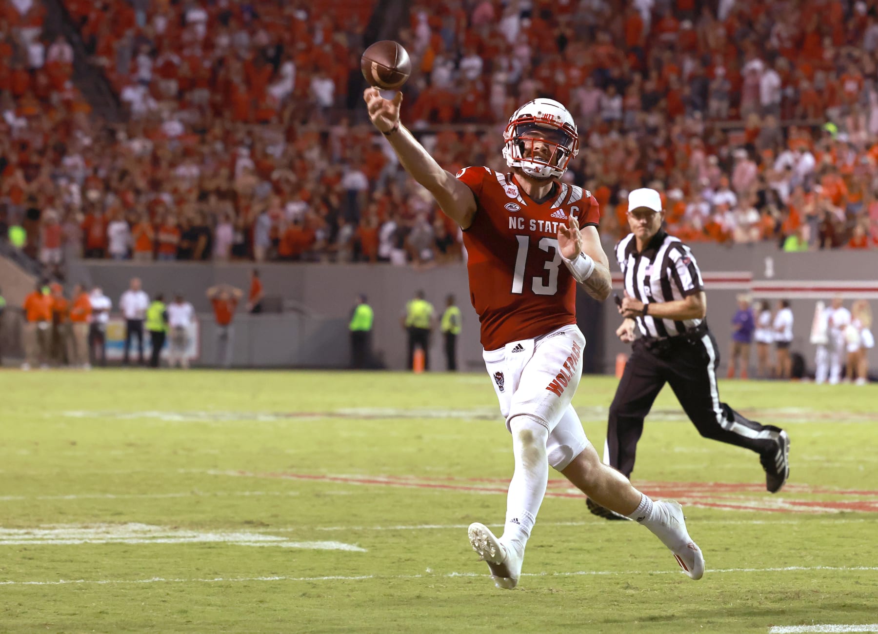 RALEIGH, NORTH CAROLINA - SEPTEMBER 25: Devin Leary #13 of the North Carolina State Wolfpack throws the game-winning touchdown against the Clemson Tigers during the second overtime of their game at Carter-Finley Stadium on September 25, 2021 in Raleigh, North Carolina. North Carolina State won 27-21 in double overtime. (Photo by Grant Halverson/Getty Images)