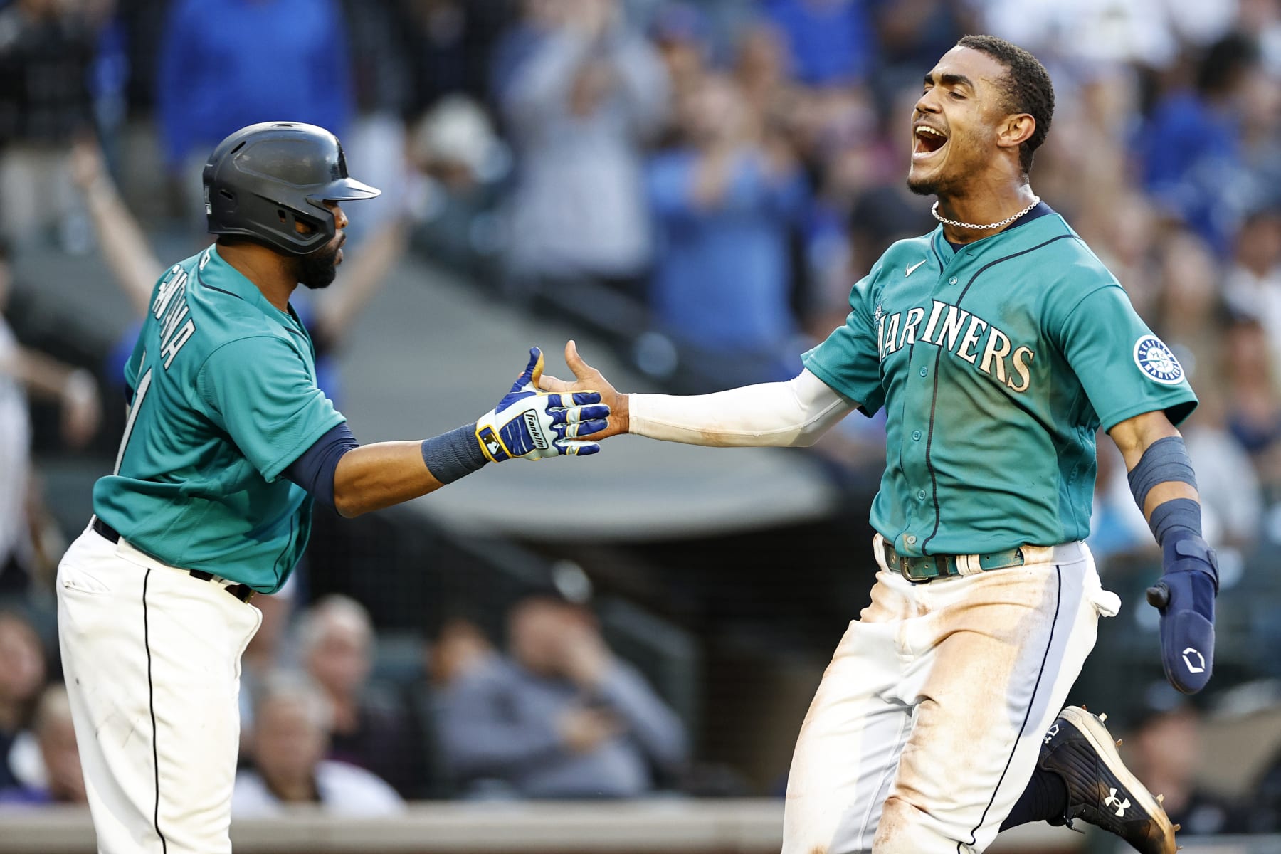 SEATTLE, WASHINGTON - JULY 08: Julio Rodriguez #44 of the Seattle Mariners celebrates a run with Carlos Santana #41 during the third inning against the Toronto Blue Jays at T-Mobile Park on July 08, 2022 in Seattle, Washington. (Photo by Steph Chambers/Getty Images)