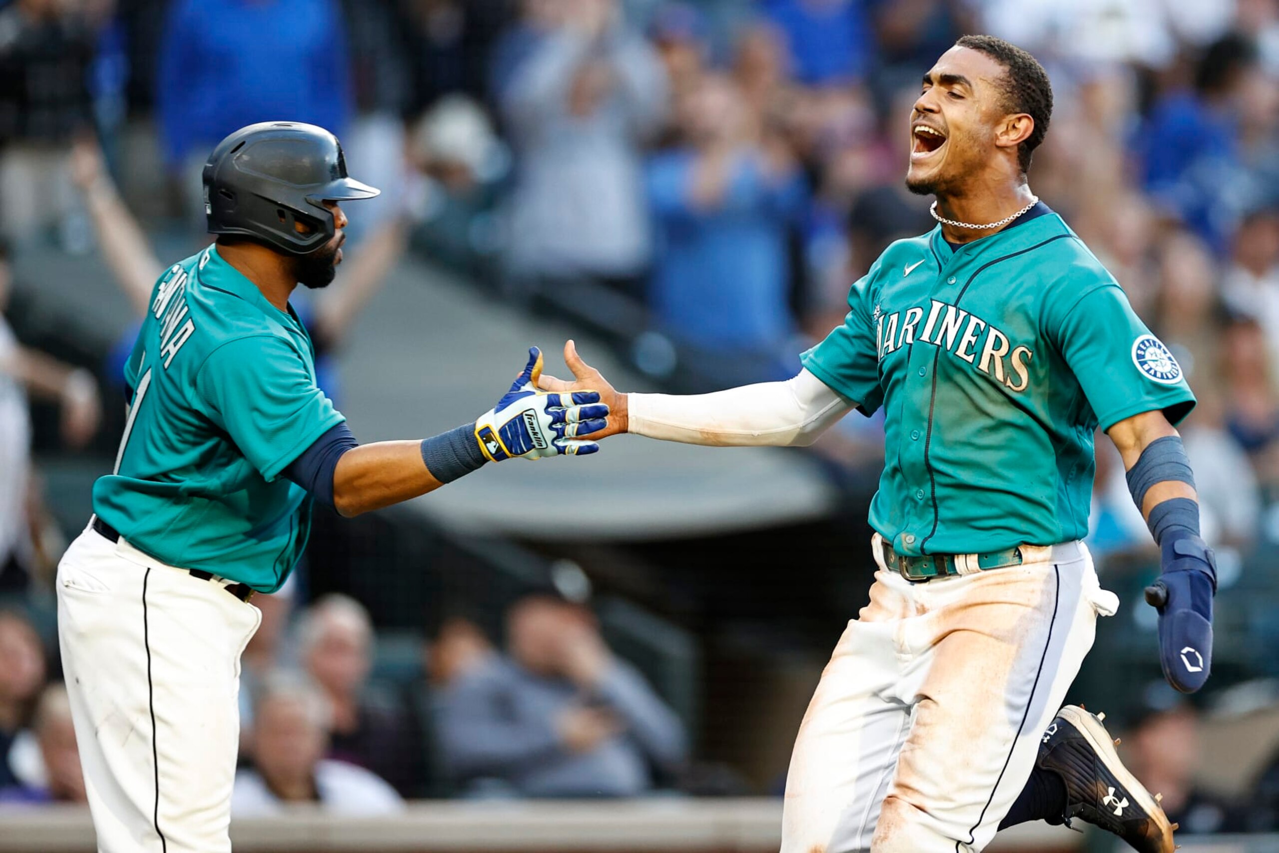 SEATTLE, WASHINGTON - JULY 08: Julio Rodriguez #44 of the Seattle Mariners celebrates a run with Carlos Santana #41 during the third inning against the Toronto Blue Jays at T-Mobile Park on July 08, 2022 in Seattle, Washington. (Photo by Steph Chambers/Getty Images)