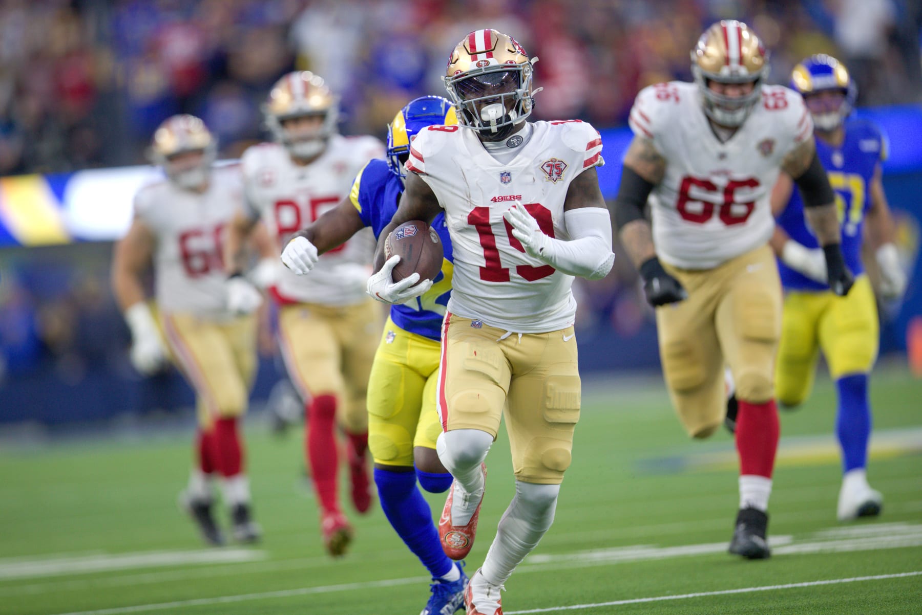 INGLEWOOD, CA - JANUARY 30: Deebo Samuel #19 of the San Francisco 49ers heads to the end zone on a 44-yard touchdown catch during the game against the Los Angeles Rams at SoFi Stadium on January 30, 2022 in Inglewood, California. The Rams defeated the 49ers 20-17. (Photo by Michael Zagaris/San Francisco 49ers/Getty Images)