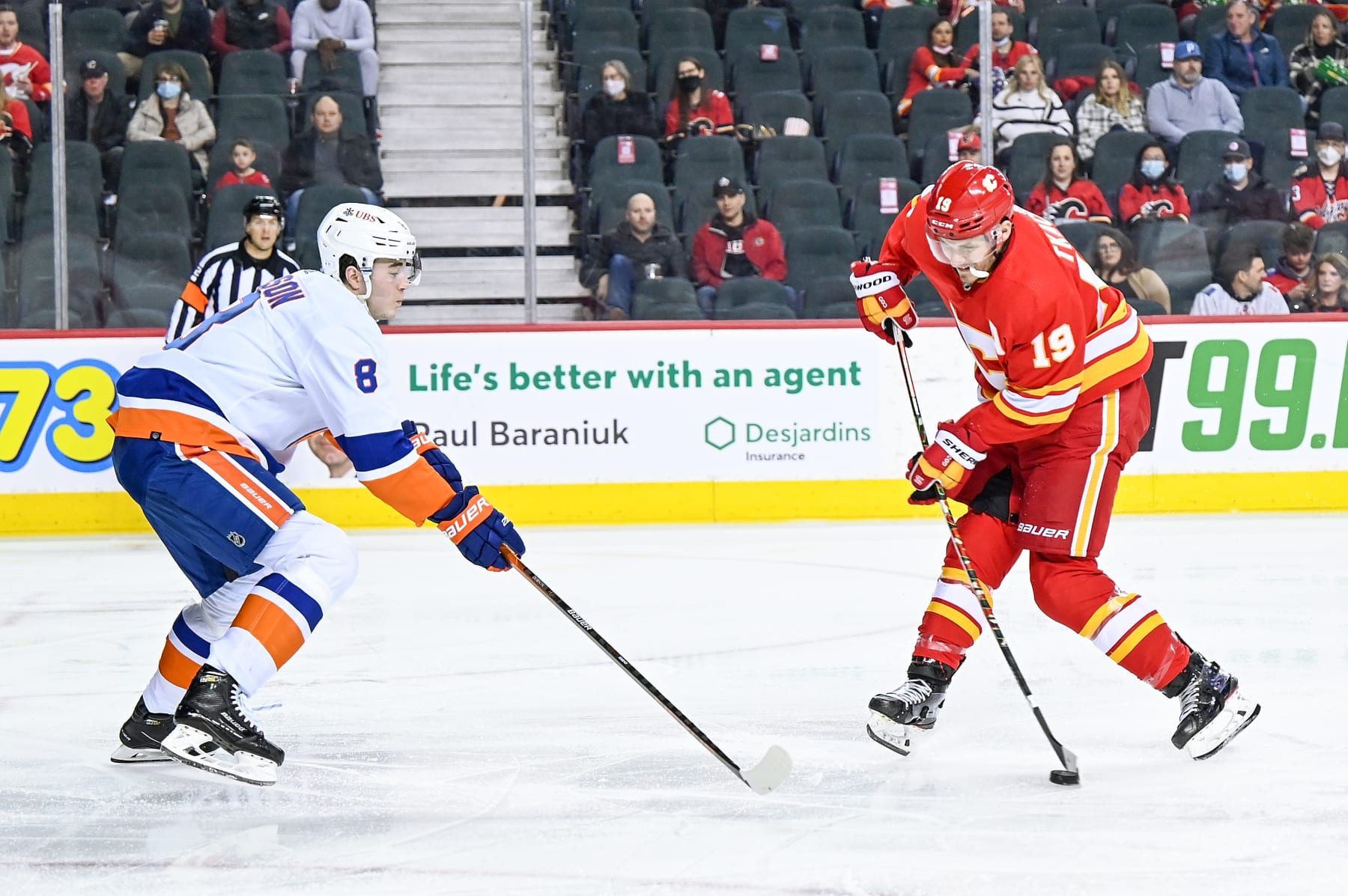 CALGARY, AB - FEBRUARY 12: Calgary Flames Right Wing Matthew Tkachuk (19) attempts a shot while New York Islanders Defenceman Noah Dobson (8) defends his zone during the second period of an NHL game where the Calgary Flames hosted the New York Islanders on February 12, 2022, at the Scotiabank Saddledome in Calgary, AB. (Photo by Brett Holmes/Icon Sportswire via Getty Images)