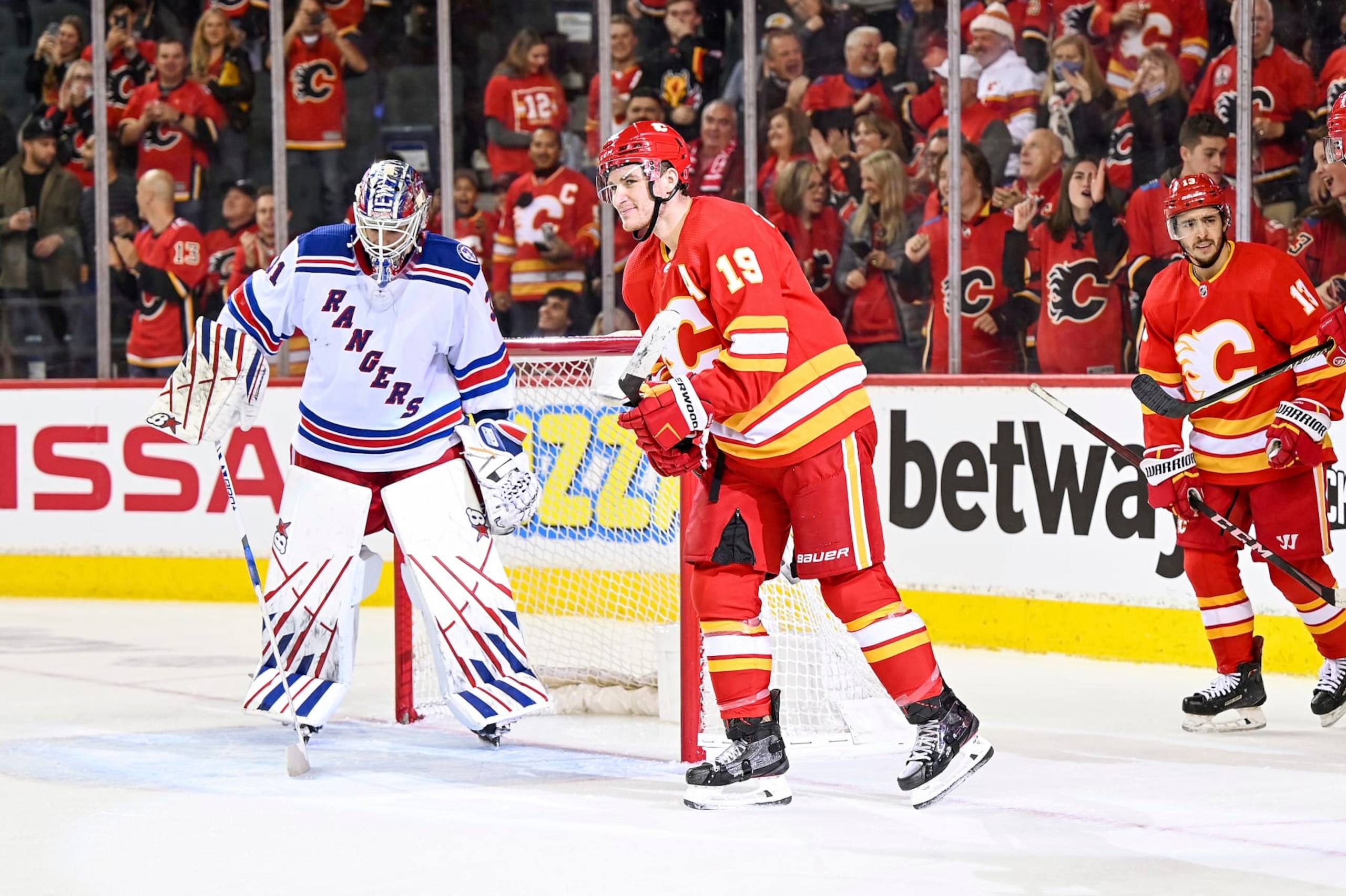 CALGARY, AB - NOVEMBER 06: Calgary Flames Right Wing Matthew Tkachuk (19) celebrates after scoring a goal with his stick between his legs during the third period of an NHL game where the Calgary Flames hosted the New York Rangers on November 6, 2021, at the Scotiabank Saddledome in Calgary, AB. (Photo by Brett Holmes/Icon Sportswire via Getty Images)
