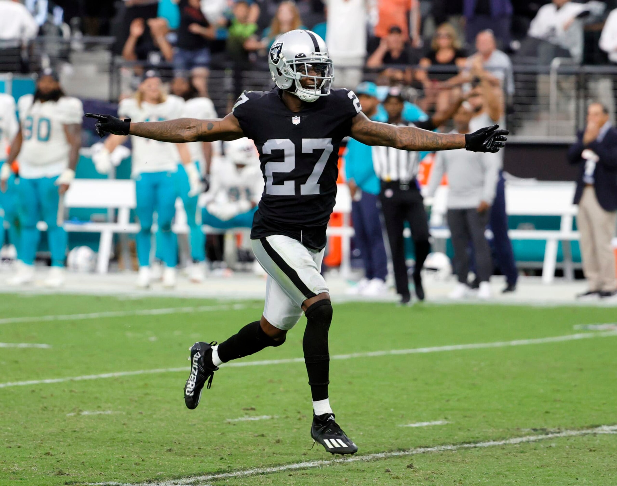 LAS VEGAS, NEVADA - SEPTEMBER 26:  Cornerback Trayvon Mullen Jr. #27 of the Las Vegas Raiders celebrates after breaking up a pass intended for wide receiver DeVante Parker #11 of the Miami Dolphins on a third-and-20 play during their game at Allegiant Stadium on September 26, 2021 in Las Vegas, Nevada. The Raiders defeated the Dolphins 31-28 in overtime.  (Photo by Ethan Miller/Getty Images)