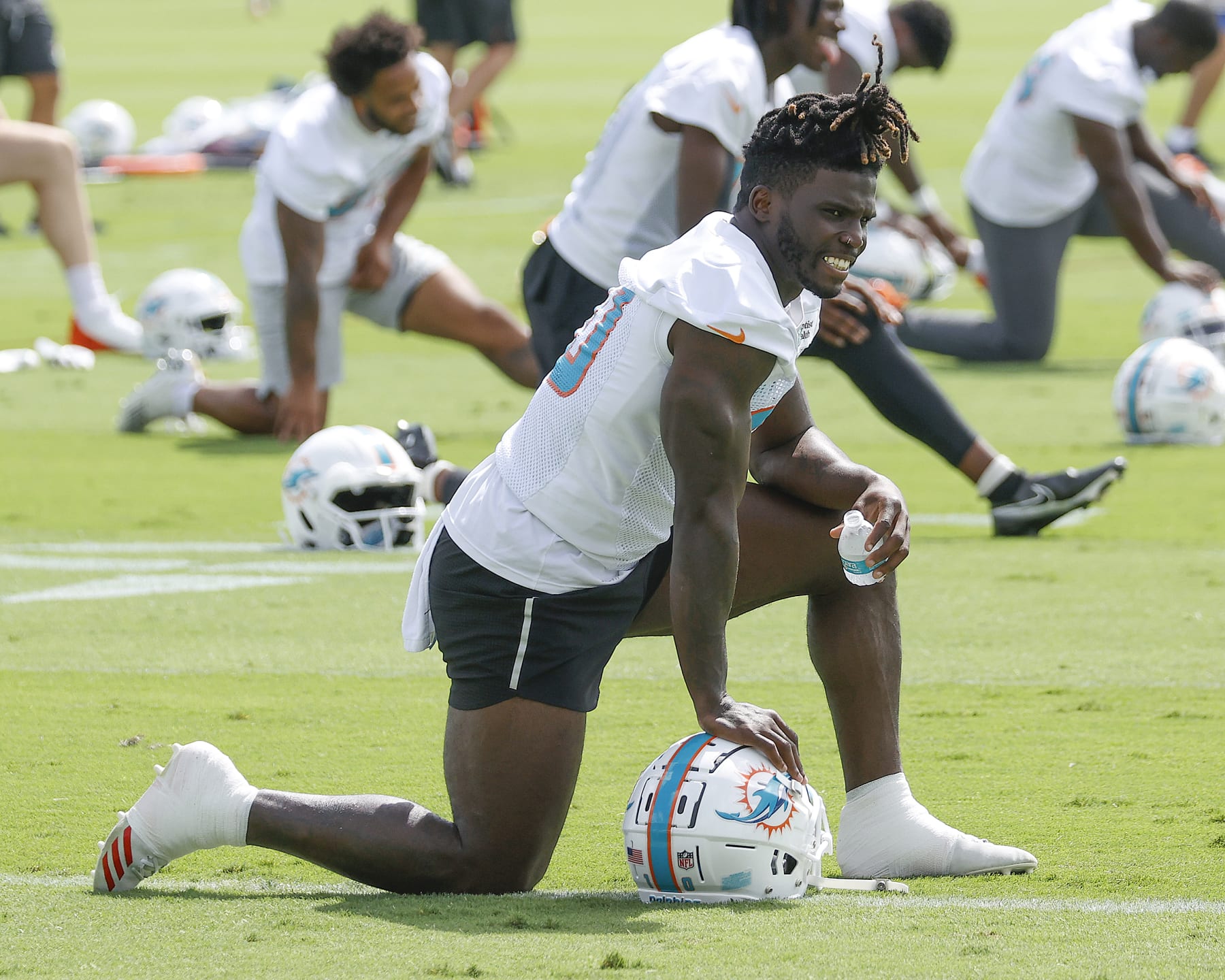 MIAMI GARDENS, FL - JUNE 2: Tyreek Hill #10 of the Miami Dolphins stretches during the Miami Dolphins Mandatory Minicamp at the Baptist Health Training Complex on June 2, 2022 in Miami Gardens, Florida. (Photo by Joel Auerbach/Getty Images)