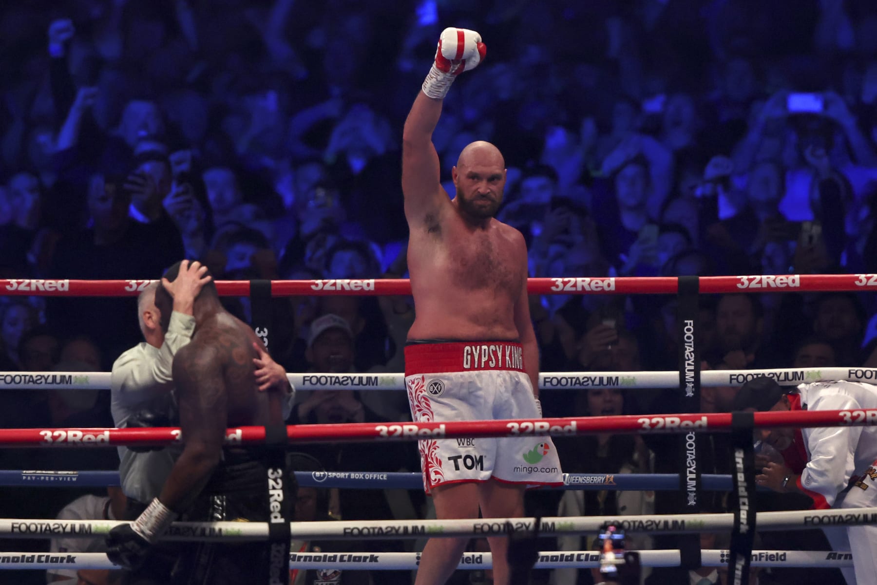 Britain's Tyson Fury, center, celebrates after beating Britain's Dillian Whyte during their WBC heavyweight title boxing fight at Wembley Stadium in London, Saturday, April 23, 2022. (AP Photo/Ian Walton)