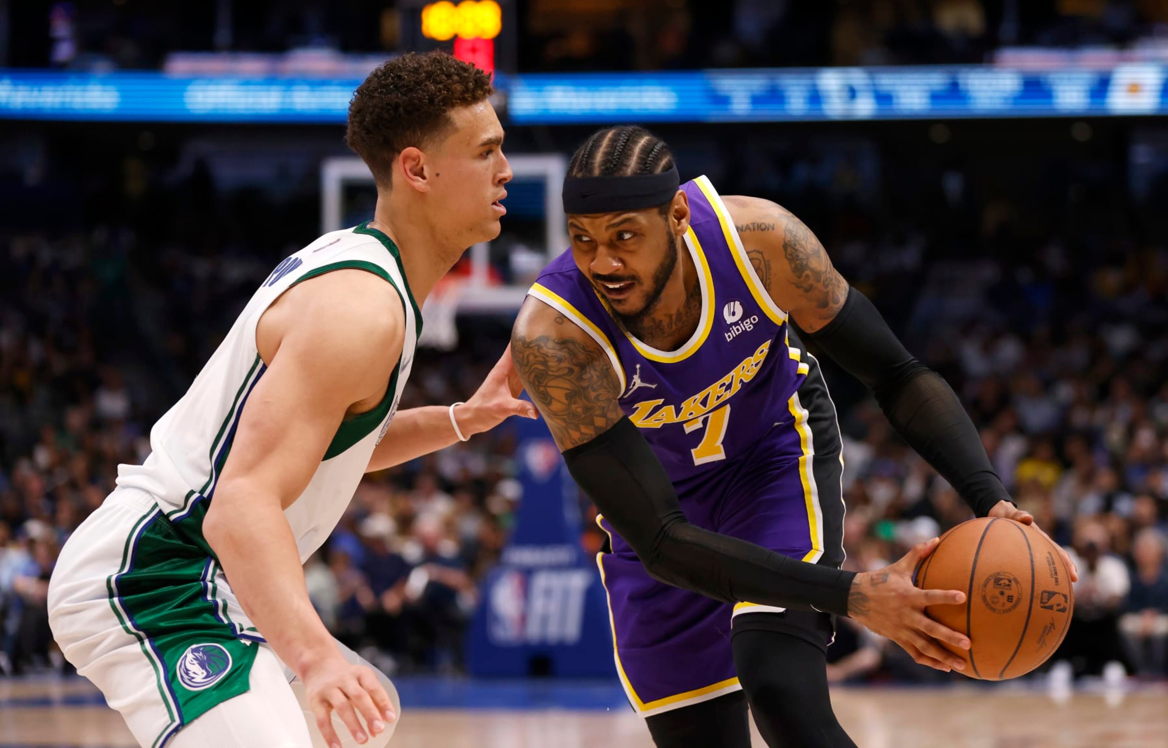 DALLAS, TX - MARCH 29: Carmelo Anthony #7 of the Los Angeles Lakers handles the ball as Dwight Powell #7 of the Dallas Mavericks defends in the second half at American Airlines Center on March 29, 2022 in Dallas, Texas. The Mavericks won 128-110. NOTE TO USER: User expressly acknowledges and agrees that, by downloading and or using this photograph, User is consenting to the terms and conditions of the Getty Images License Agreement. (Photo by Ron Jenkins/Getty Images)